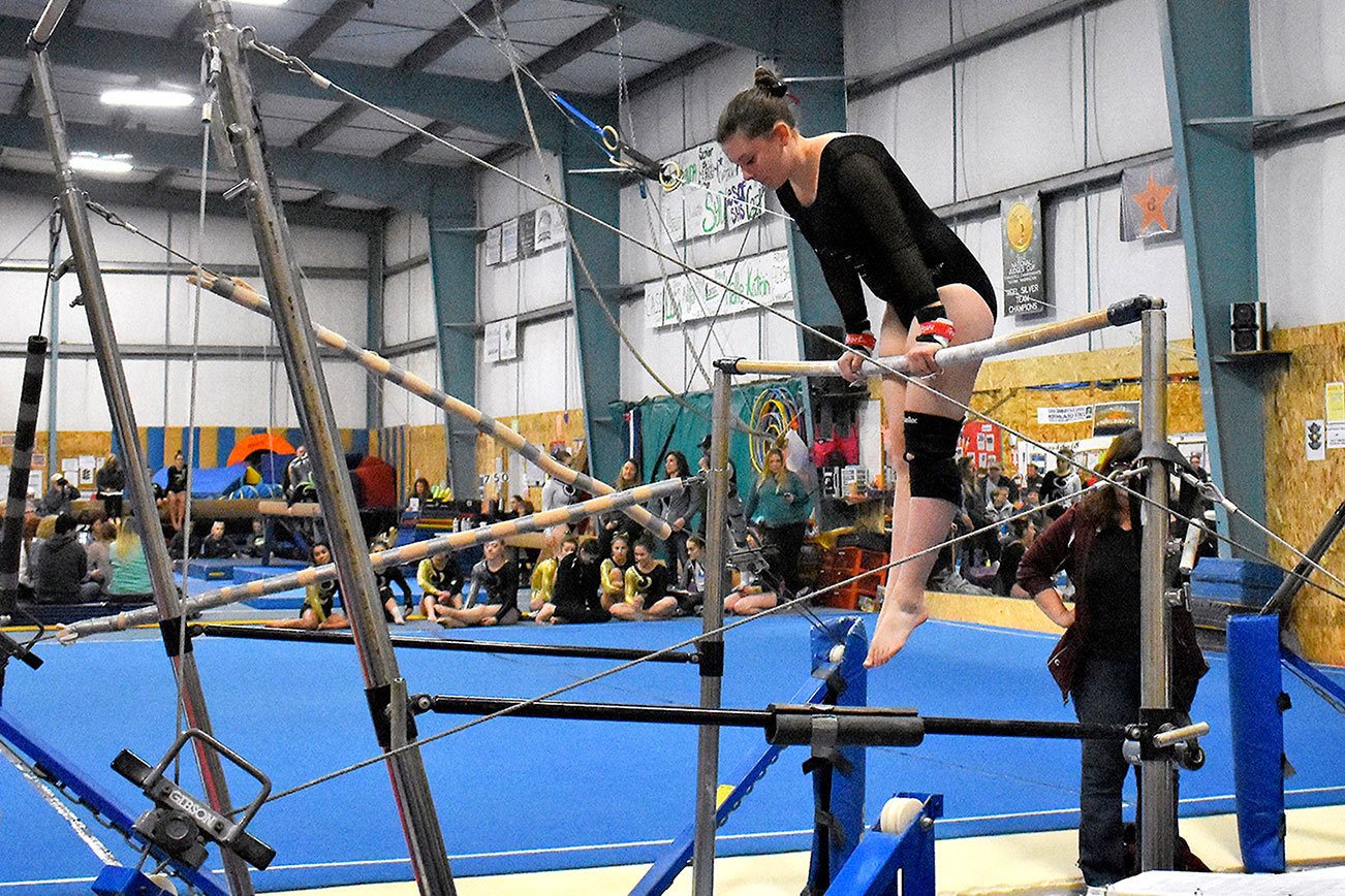 Annelise Pardee prepares to perform a front hip circle on the low bar during the team’s Port Angeles quad meet Jan. 16. Sheila Moore / Submitted