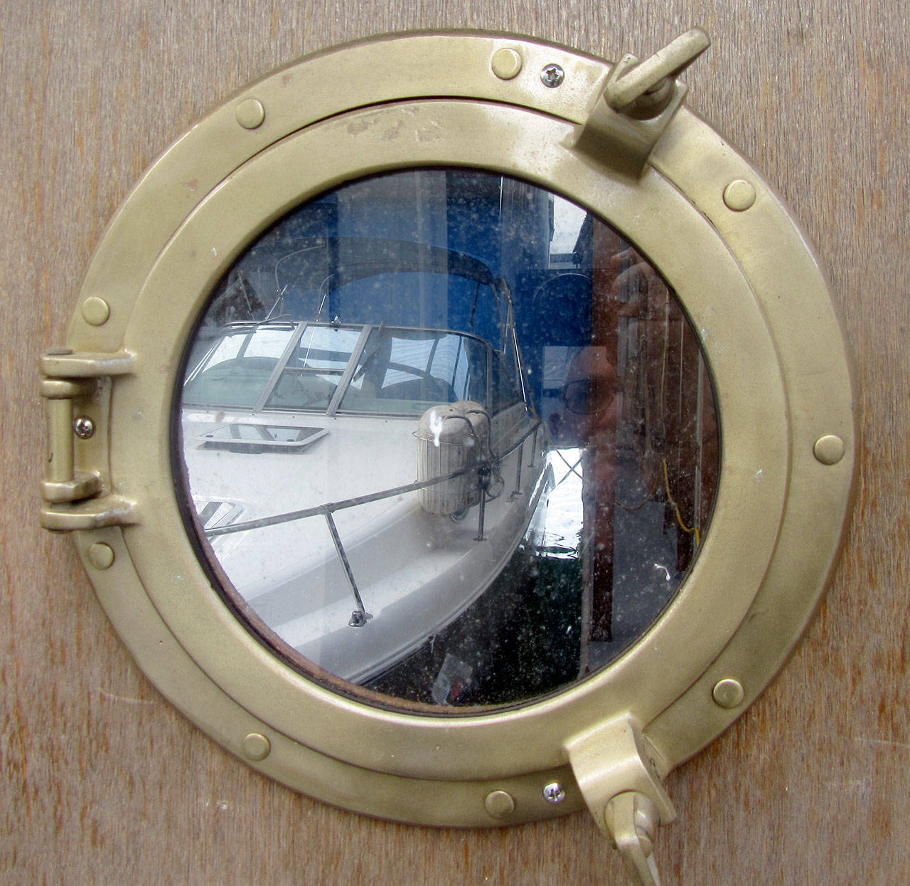 A bronze porthole invites passersby to admire the owner’s boat.                                Terryl Asla/Kitsap News Group