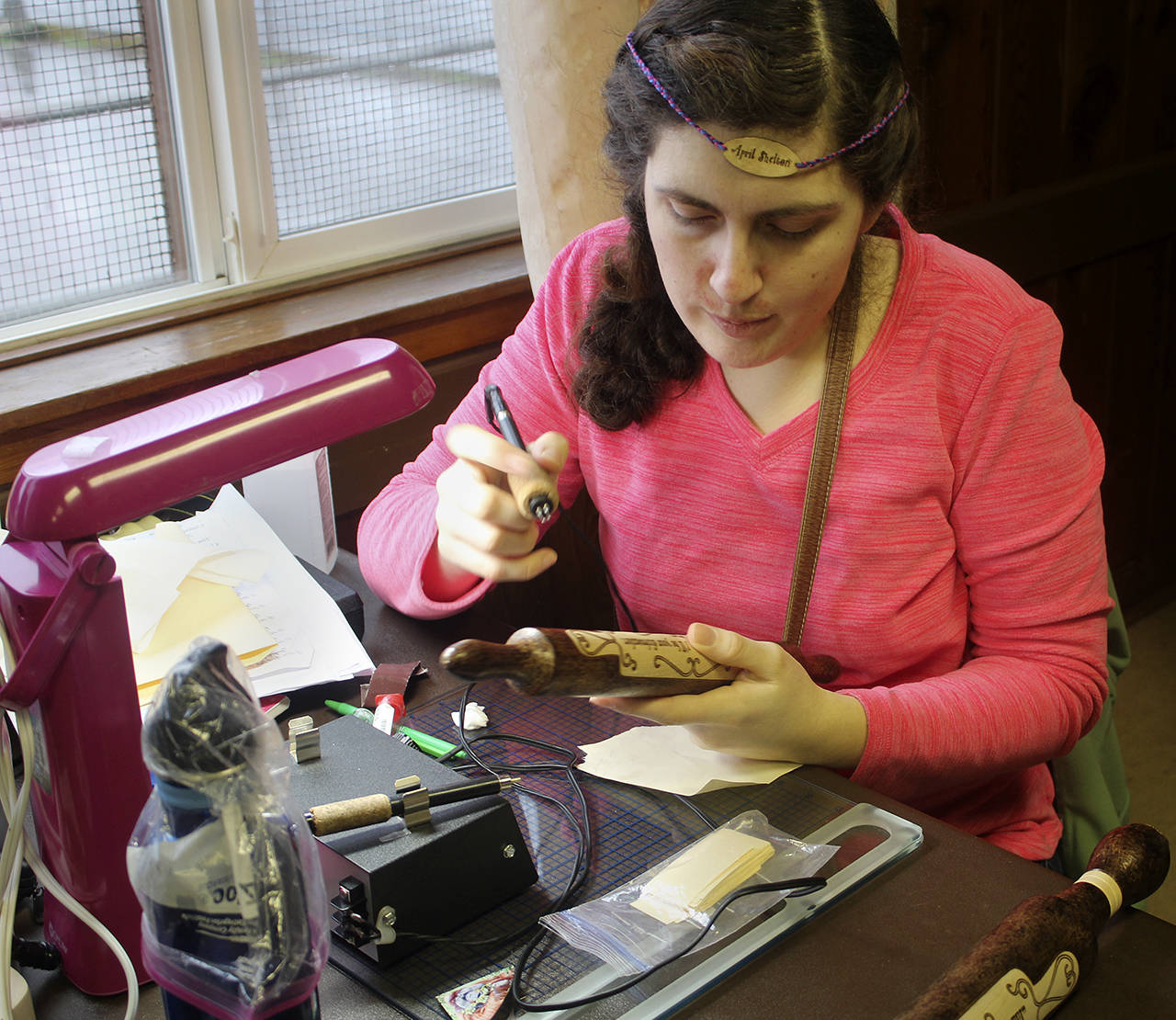 April Shelton works on a simple pyrographic image on a rolling pin.                                Terryl Asla/Ktsap News Group