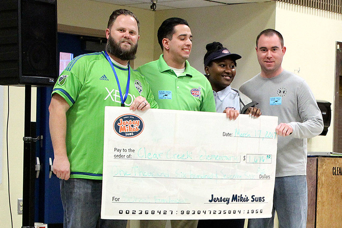 From right, Clear Creek Elementary Principal Steve Potter, Jersey Mike’s employee Stachia White, Jersey Mike’s manager Matt Bullatt, and Clear Creek PTA President Matt Carlan with a check for $1,676, which Jersey Mike’s raised to benefit Clear Creek Elementary’s PTA. Michelle Beahm / Kitsap News Group