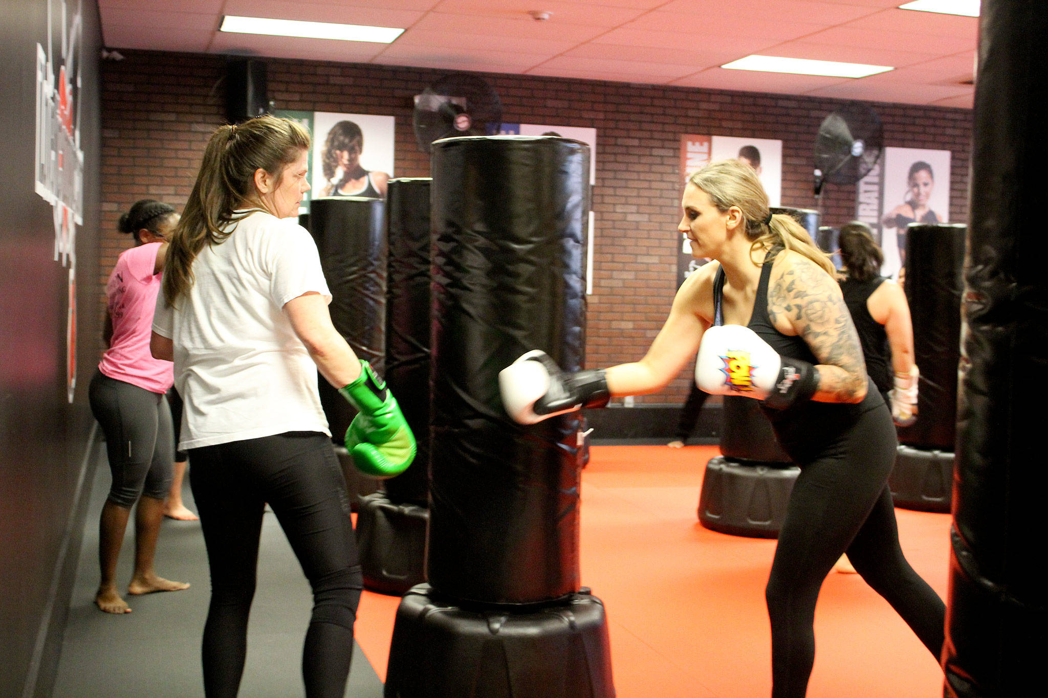 Classes at iLoveKickboxing are high energy, high intensity workouts, which up to about 30 people can participate in at a time. Throughout the classes, instructors go around helping people correct their form and encouraging them to keep pushing.                                Michelle Beahm / Kitsap News Group