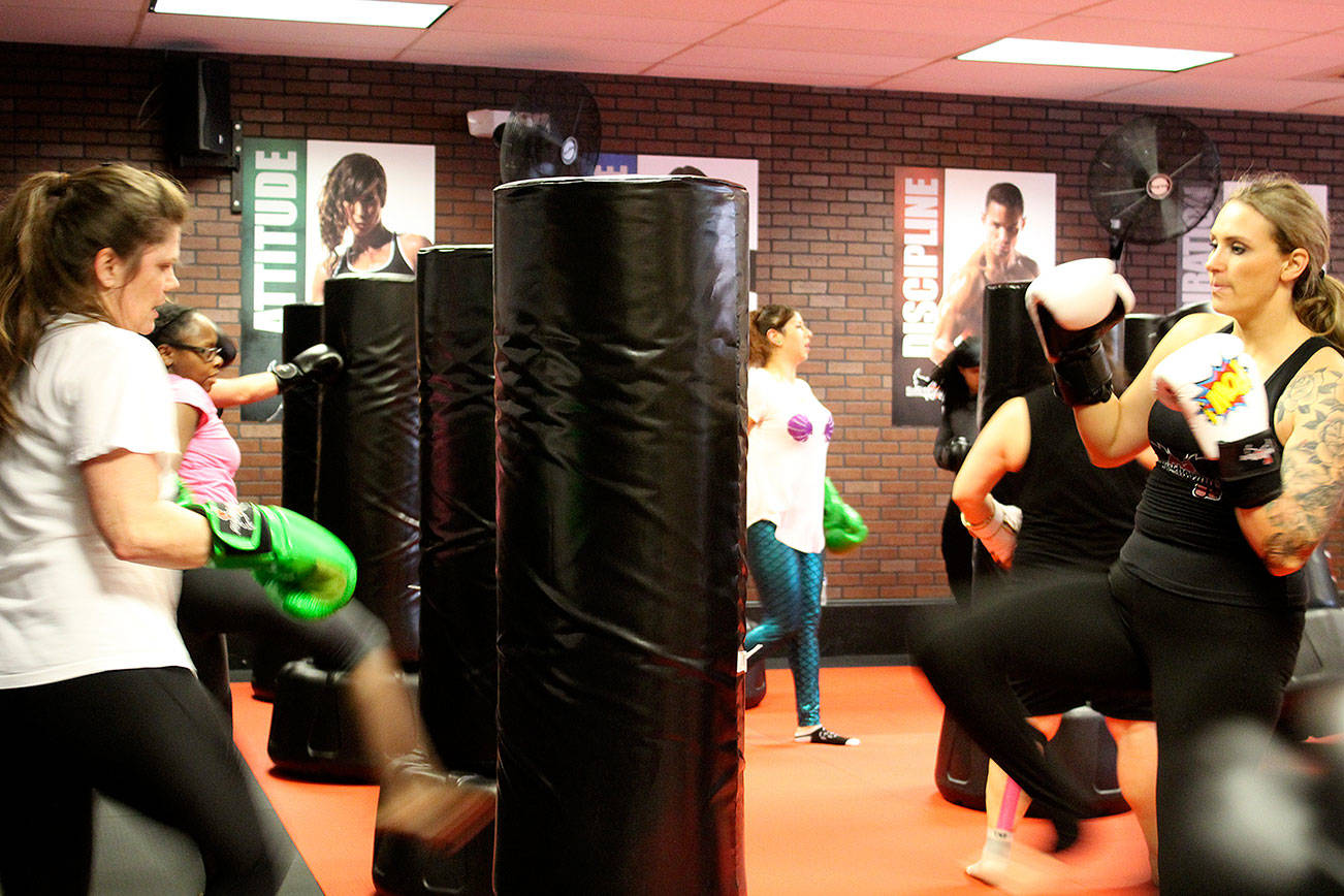 Classes at iLoveKickboxing are high energy, high intensity workouts, which up to about 30 people can participate in at a time. Throughout the classes, instructors go around helping people correct their form and encouraging them to keep pushing.                                Michelle Beahm / Kitsap News Group