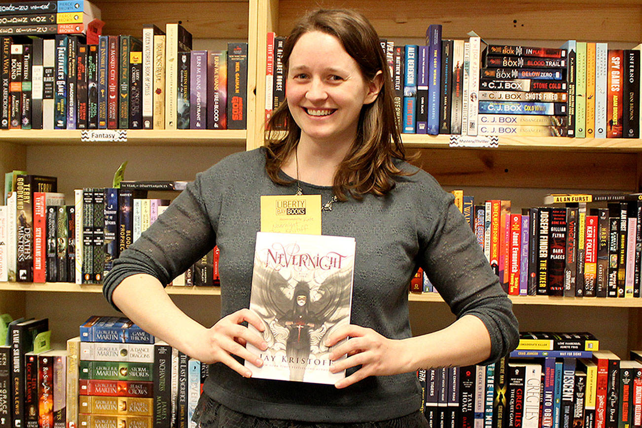 Kate Daniels, manager of Liberty Bay Books in Bremerton, shows off one of her favorite books in the store. Daniels said Independent Bookstore Day is “a day of celebration and for people who love reading and books and talking about books and all of the things that are nerdy and fun like that.”                                Michelle Beahm / Kitsap News Group
