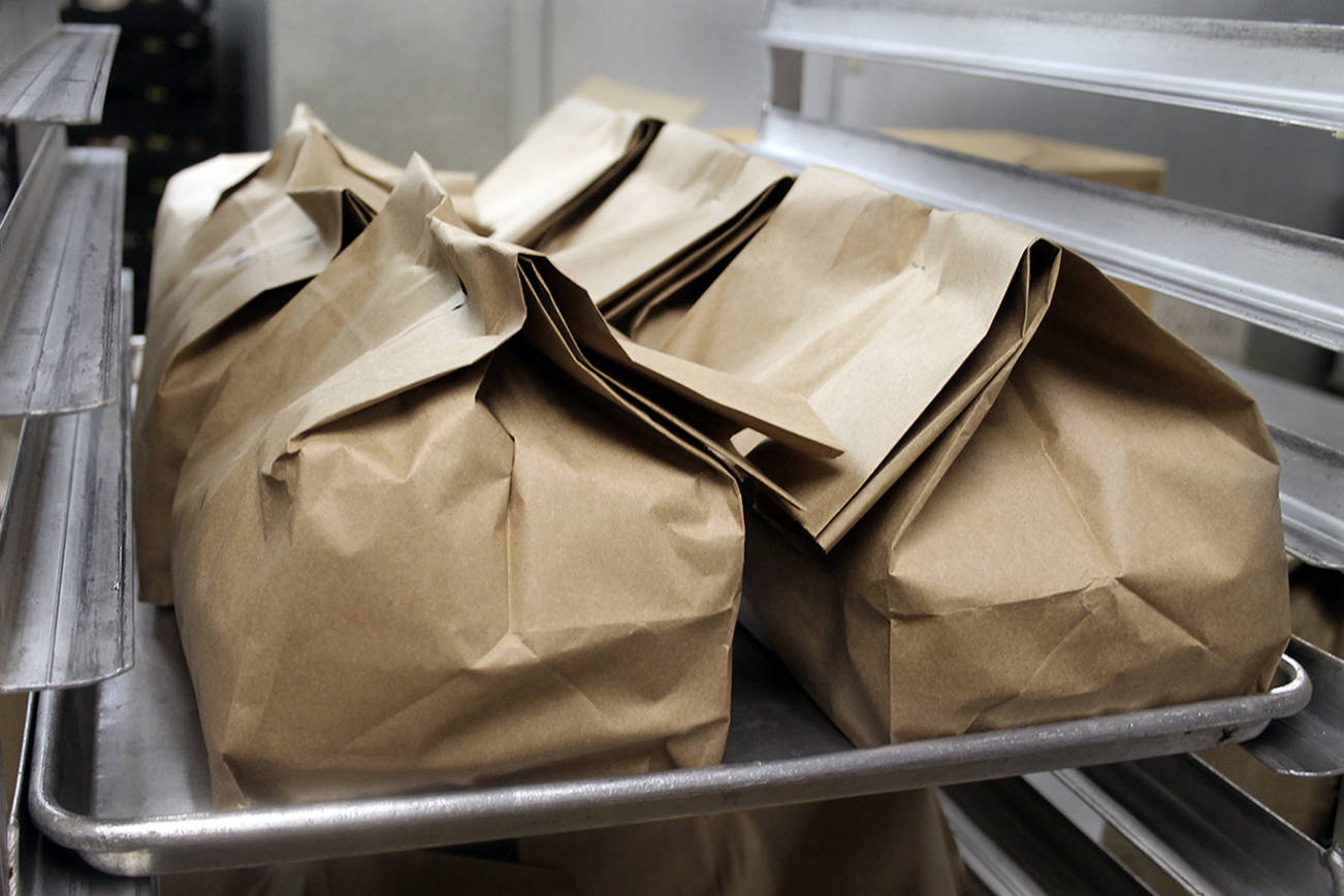 Bags with two frozen meals go out with the hot meal on Fridays so older adults will have food to eat over the weekend. (Terryl Asla/Kitsap News Group)