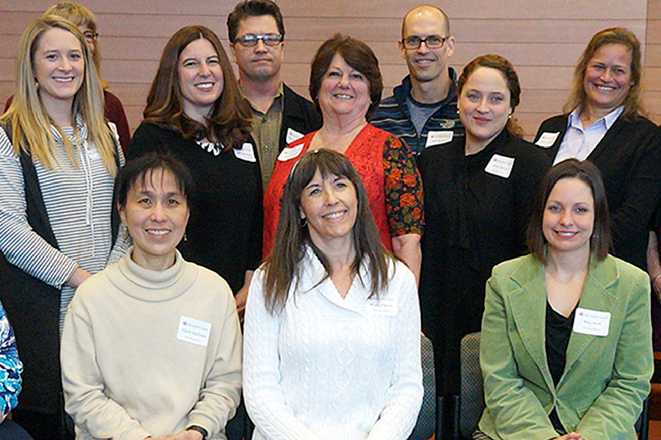 Nineteen Kitsap County teachers and paraprofessional instructors were recognized as Outstanding Educators at an awards ceremony and reception on March 21 in the Poulsbo City Hall Council Chambers. Standing from left, Barb Haga, Shelly Shockly, Mackenzie Allpress, Susan James, Julie Bowman, Michael McCurdy, Linda Brazeau, Mike McCorkle, Elisa Garcia, Betsy Carlson, Barbara Vandeleur, Drew Crandall, Michael Woods. Seated from left, Patty Moore, Claire Hallinan, Wendy Tweten, Amy Roth, Catherine Campbell, and Nathanial Zawlocki. Not pictured: Peggy Dunbar. (Contributed photo)