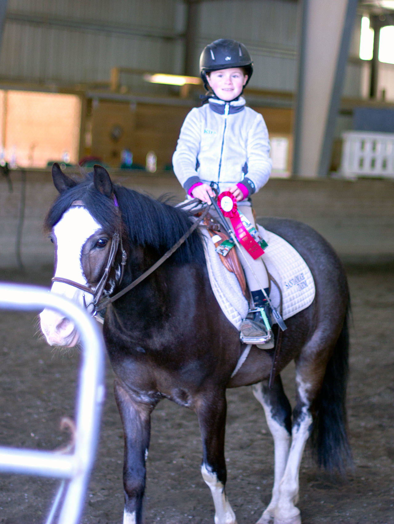 Kira O’Malley poses with her ribbons from the Sandamar Farm Winter Series show, April 15. (Sophie Bonomi / Kitsap News Group)