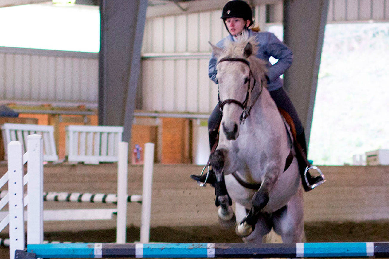 Jada Hertz, 14, and Hugo sail over a 2-foot-9-inch jump during an English event at Sandamar Farm April 15. (Sophie Bonomi / Kitsap Daily News)