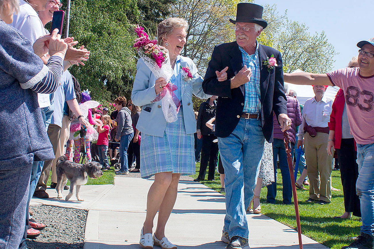 Community members cheer as Ardis Morrow and Bill Austin arrive at Kvelstad-Austin Pavilion in downtown Poulsbo for a celebration honoring their contributions to the community, in 2015. The two will again be honored on May 20 when they serve as grand marshals of the 2017 Viking Fest Parade. (Sophie Bonomi/2015)