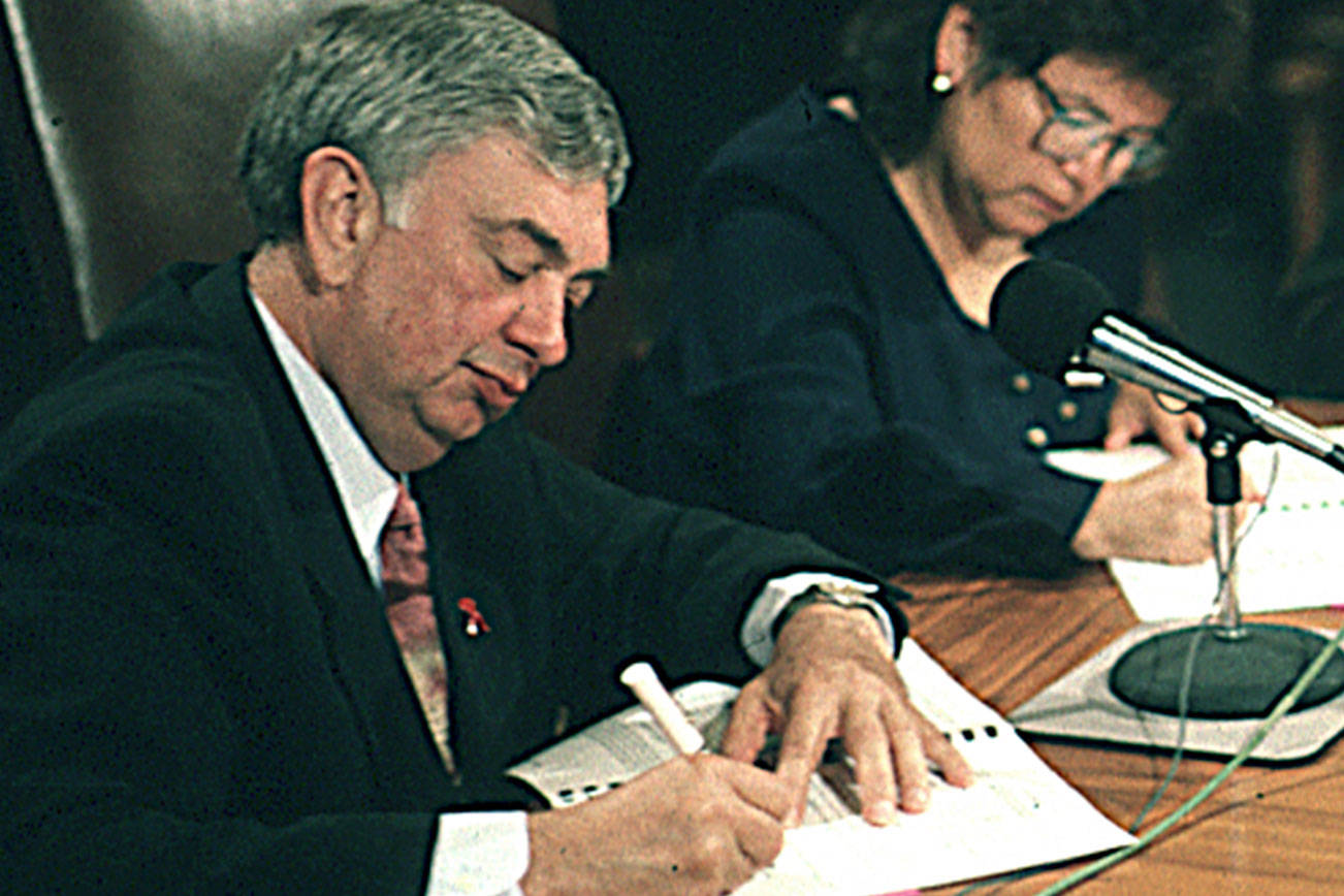 Gov. Mike Lowry and Quinault Nation President Pearl Capoeman Baller sign the compact related to the Quinault Beach Resort & Casino. Looking on is Quinault Councilman Ray Lorton. (Larry Workman/Quinault Nation)