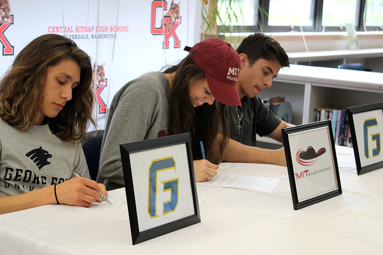 From left, Caleb Giesbrecht, Katelyn Downey and Cody Davis committed to universities May 31. Giesbrecht will be on the cross country team for George Fox University, Downey will be a volleyball player at MIT and Davis will be on the track and field team at George Fox University.                                Michelle Beahm / Kitsap News Group