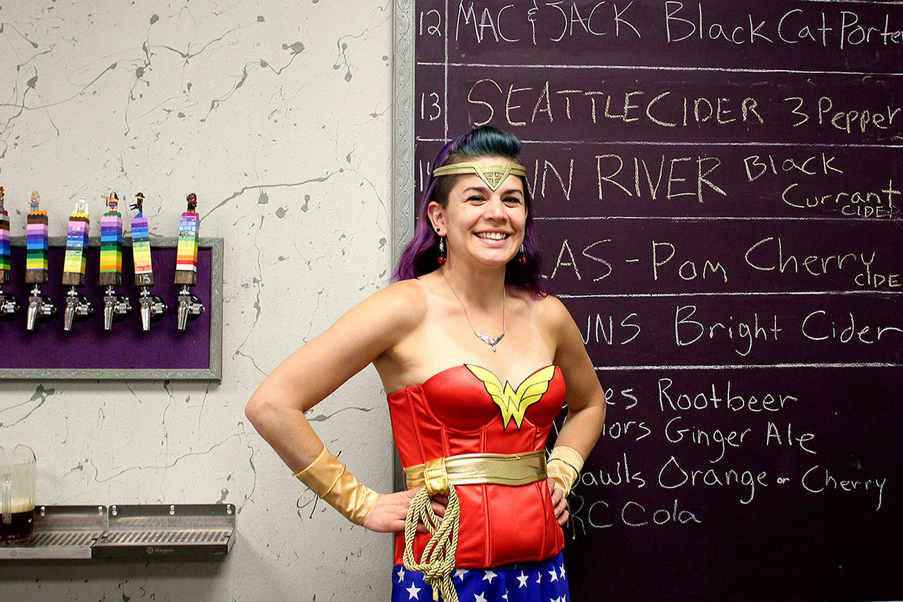 Ashley Martinez, owner of Ashley’s Pub: Boardom’s End, dressed as her favorite comic book character Wonder Woman for the grand opening of her bar. Michelle Beahm / Kitsap News Group