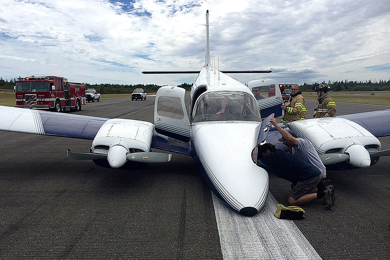 A twin-engine airplane’s nose landing gear did not extend, forcing the pilot to land without it. He made a ‘textbook’ landing, with minimal damage to the plane and runway, and all three people on board exited uninjured.                                Photo courtesy South Kitsap Fire and Rescue
