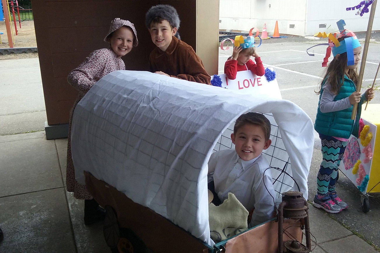 Others went all out and wore period clothing, parading with own covered wagons made of paper and chicken wire. (Ian A. Snively/Kitsap News Group)