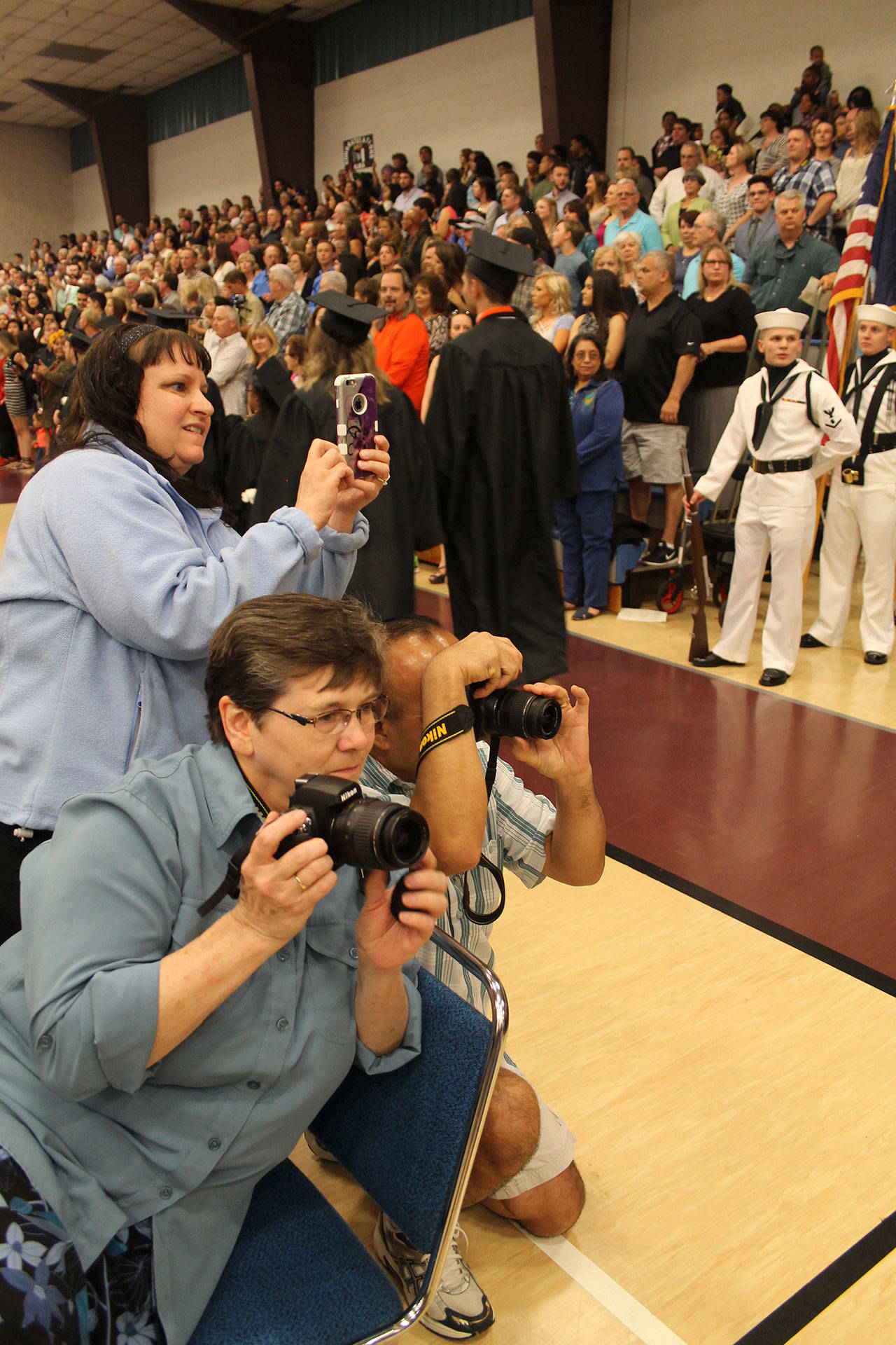 Proud family members strive to capture a picture of their graduates.                                Terryl Asla| Kitsap News Group