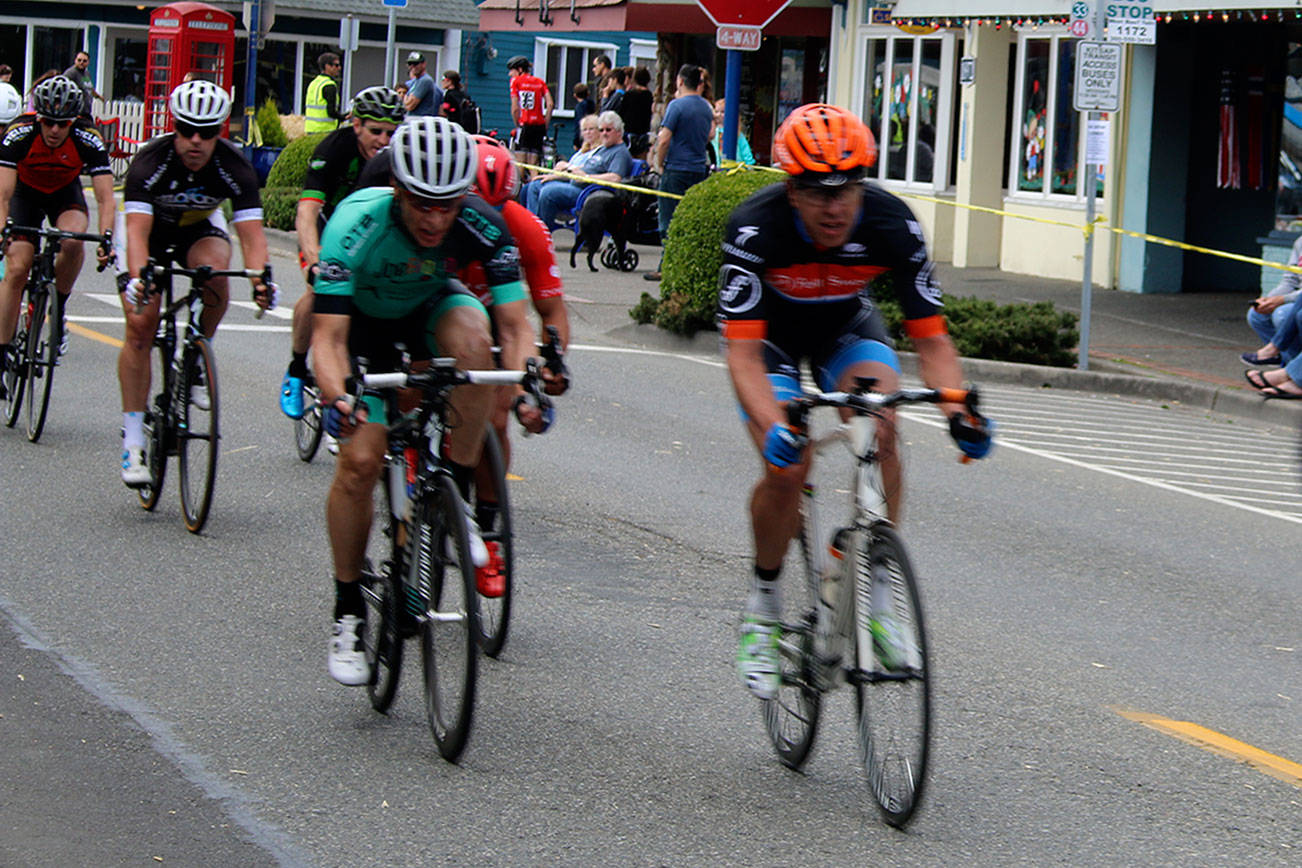 As cyclists raced past Nordic storefronts on narrow downtown Front Street, spectators sipped coffee drinks from sidewalk tables or enjoyed tapas in an outdoor dining area set up in front of Burrata Bistro. This could have been a European city. But this was a Saturday afternoon in Poulsbo, and the event was the Poulsbo Twilight Criterium. (Richard Walker/Kitsap News Group)