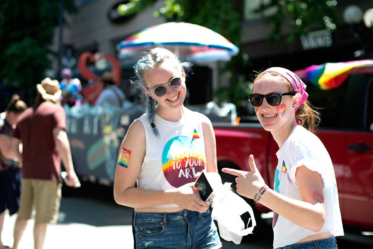Listen to Your Art committee members Annika Nelson, left, and Skylar Kaster distributed more than 5,000 brochures at the Seattle Pride Parade June 25. (Espen Swanson/Contributed)