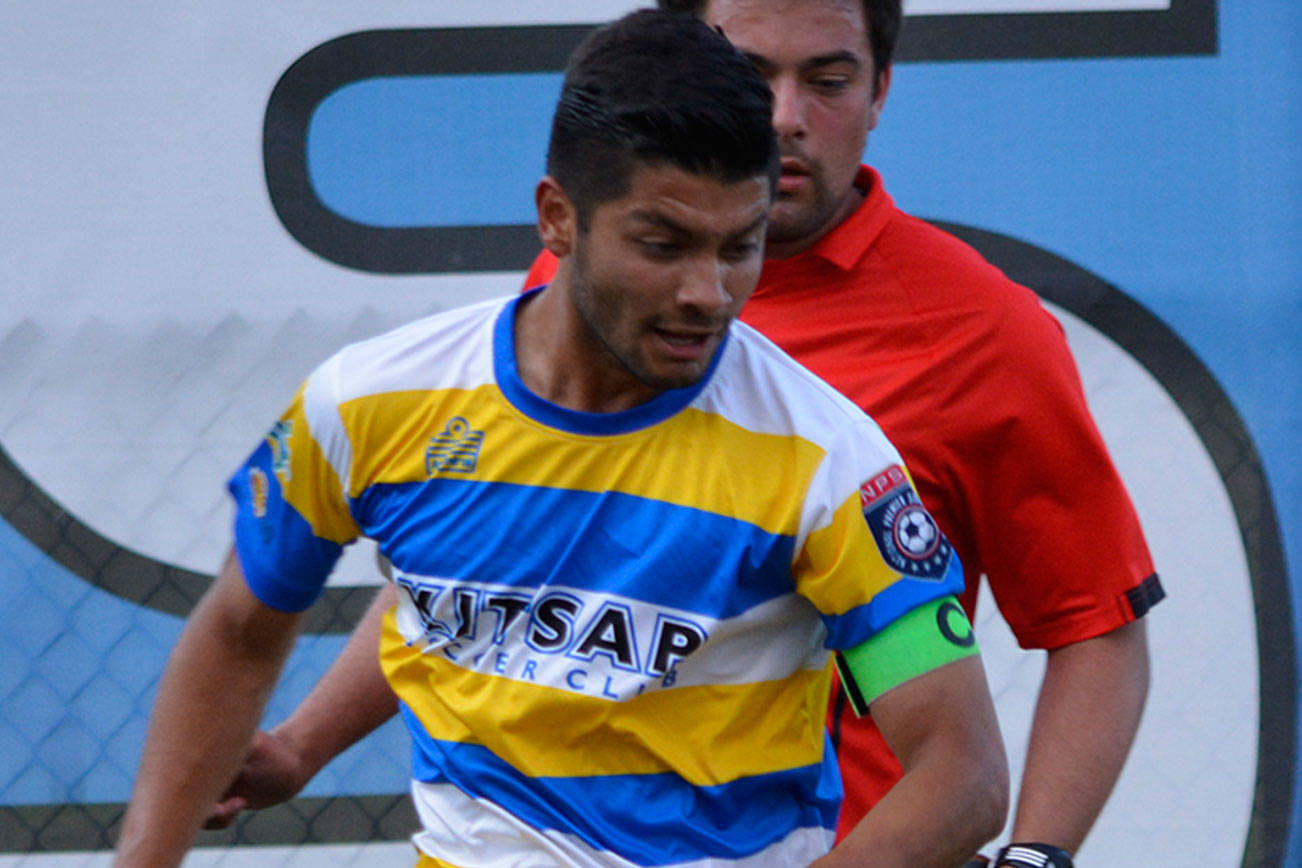 Kitsap SC midfielder Jesus Sanchez attempts to dribble past Portland midfielder Ryan Callahan during the July 15 first round playoff match. (Mark Krulish/Kitsap News Group)