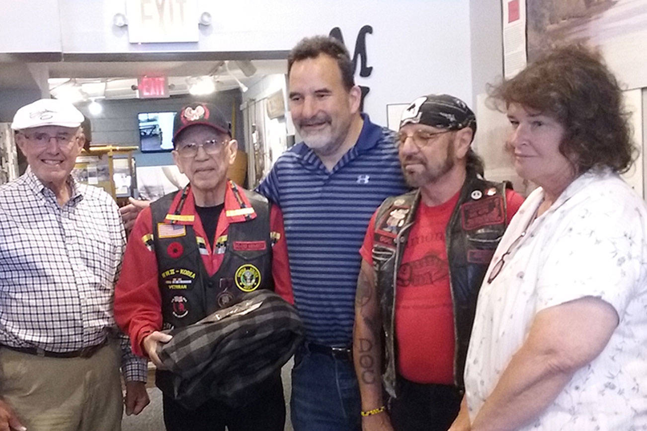 The Suquamish Tribe presents a model of a Coast Salish canoe to the Poulsbo Maritime Museum, July 14. (Ian A. Snively/Kitsap News Group)