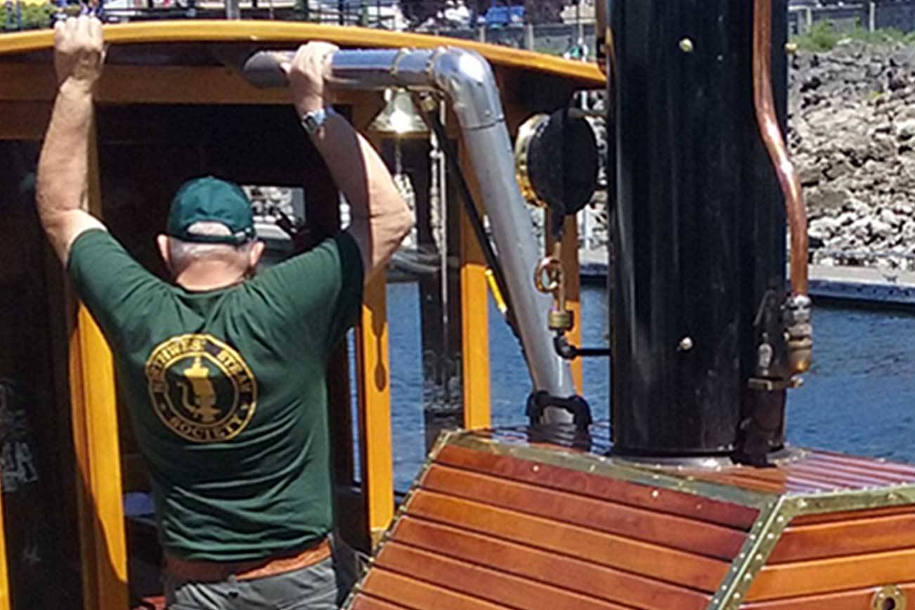 Dunlap climbs into his custom paddle boat, which took him 20 years to make.                                Ian Snively / Kitsap News Group