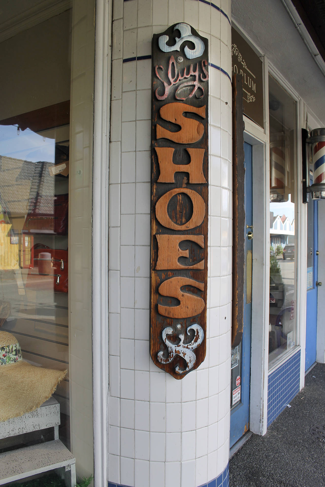 Look carefully: the carved wooden sign advertising the Indigo Plum shoe store is really a holdover from the days when the Sluys had a shoe store on Front Street.                                Terryl Asla/Kitsap News Group