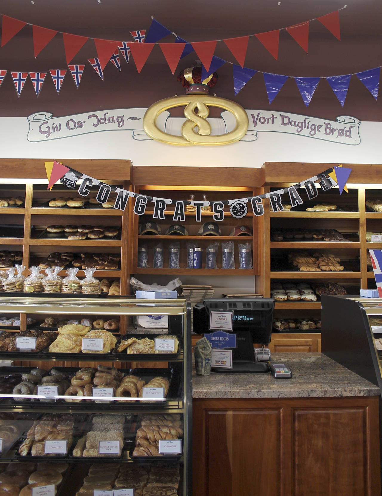 The golden pretzel on the wall behind the counter in Sluys’ Bakery. The motto below it says “Give us this day our daily bread” in Norwegian.                                Terryl Asla/Kitsap News Group