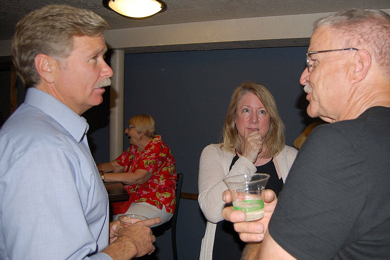 Left, Bremerton City Council member Greg Wheeler visits with supporters at The Toro Lounge, Aug. 1. Wheeler finished first in the primary for mayor. (Bob Smith/Kitsap News Group)