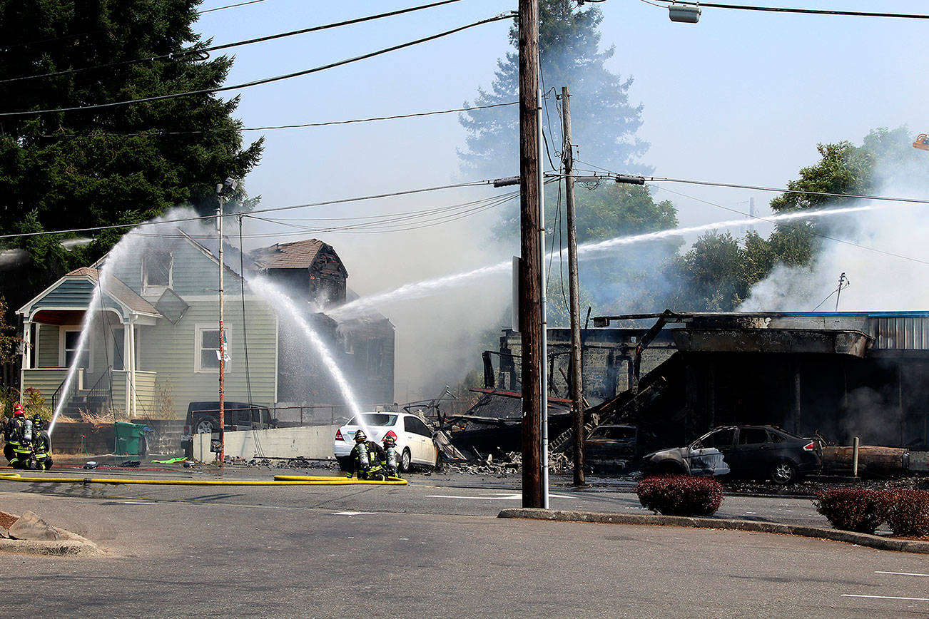 Crews from the Bremerton, South Kitsap, Central Kitsap and Navy Region Northwest fire departments work together to put out a two-alarm fire that started in Motor City Automotive, at the corner of North Callow Avenue and 11th Street, around 12:16 p.m. Aug. 3.                                Michelle Beahm / Kitsap News Group