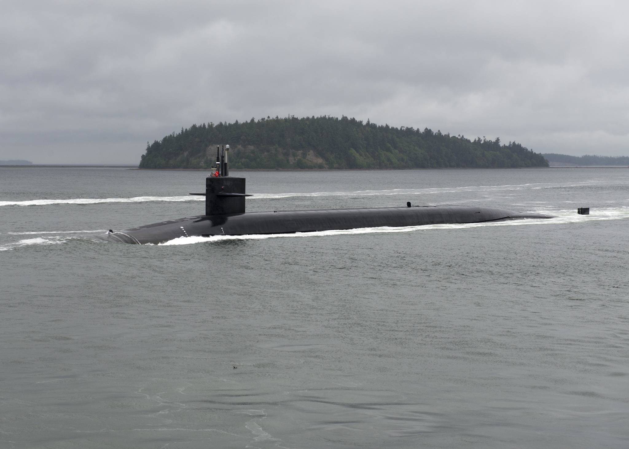 The Ohio-class ballistic-missile submarine USS Kentucky transits the Hood Canal on June 15 as it returns to Naval Base Kitsap, following a strategic deterrent patrol. Defense Secretary Jim Mattis will meet with the submarine’s crew during a visit to the base. Petty Officer 1st Class Amanda R. Gray/U.S. Navy