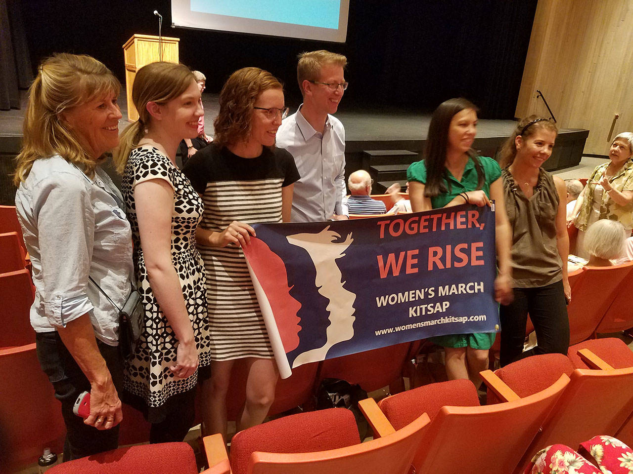 U.S. Rep. Derek Kilmer, D-Gig Harbor, poses with members of Women’s March Kitsap at his town hall meeting Aug. 9, in the North Kitsap Auditorium. (Terryl Asla/Kitsap News Group)