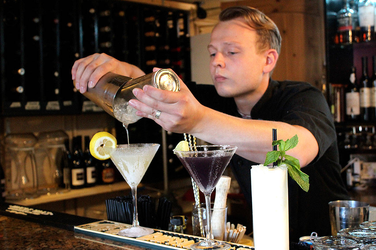 Nathan Abbott, general manager of the Bay Street Bistro, mixes three signature cocktails.                                Michelle Beahm / Kitsap News Group