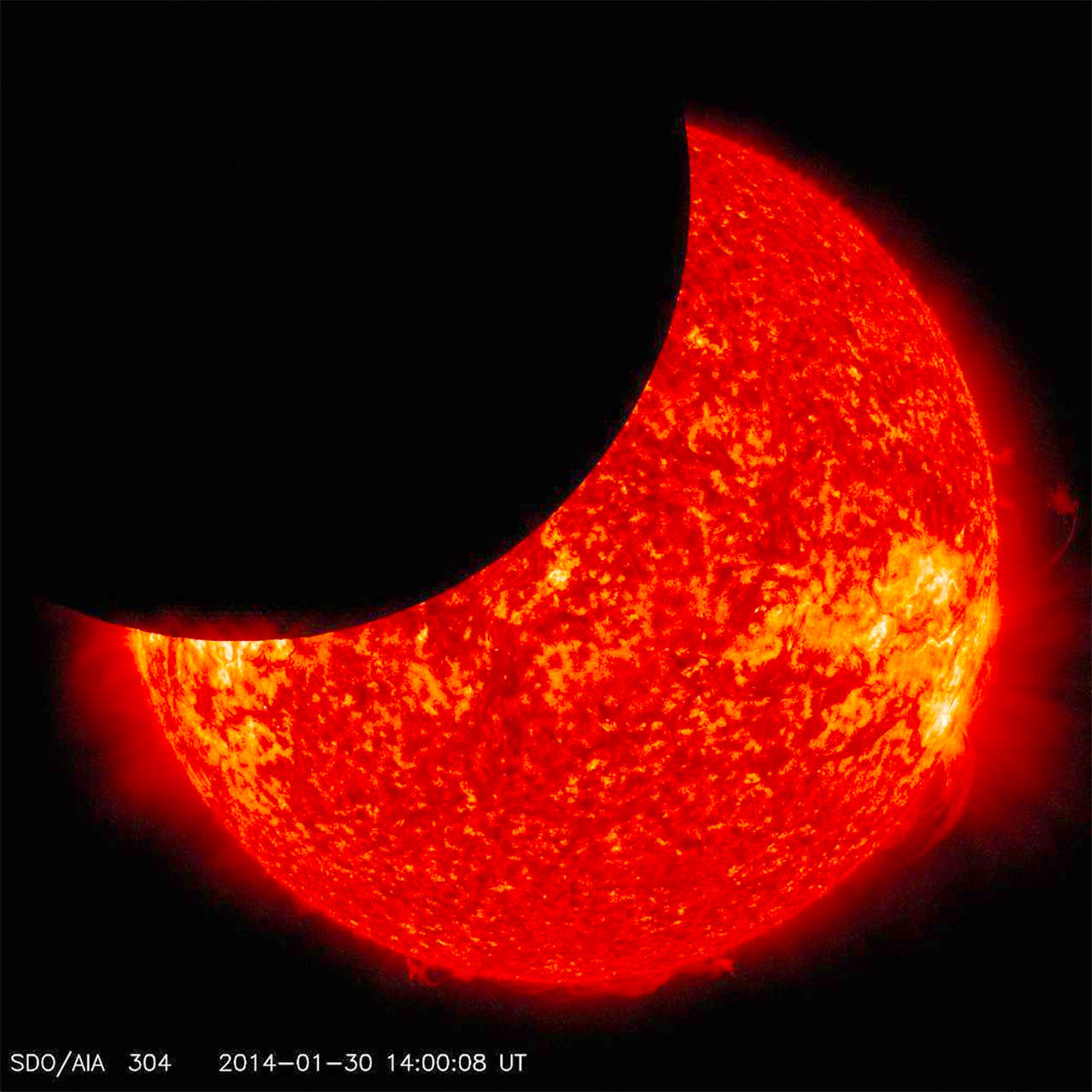 On Jan. 30, 2014, beginning at 8:31 a.m EST, the moon moved between NASA’s Solar Dynamics Observatory, or SDO, and the sun, giving the observatory a view of a partial solar eclipse from space. Such a lunar transit happens two to three times each year. This one lasted two and one half hours, which is the longest ever recorded.                                NASA/SDO