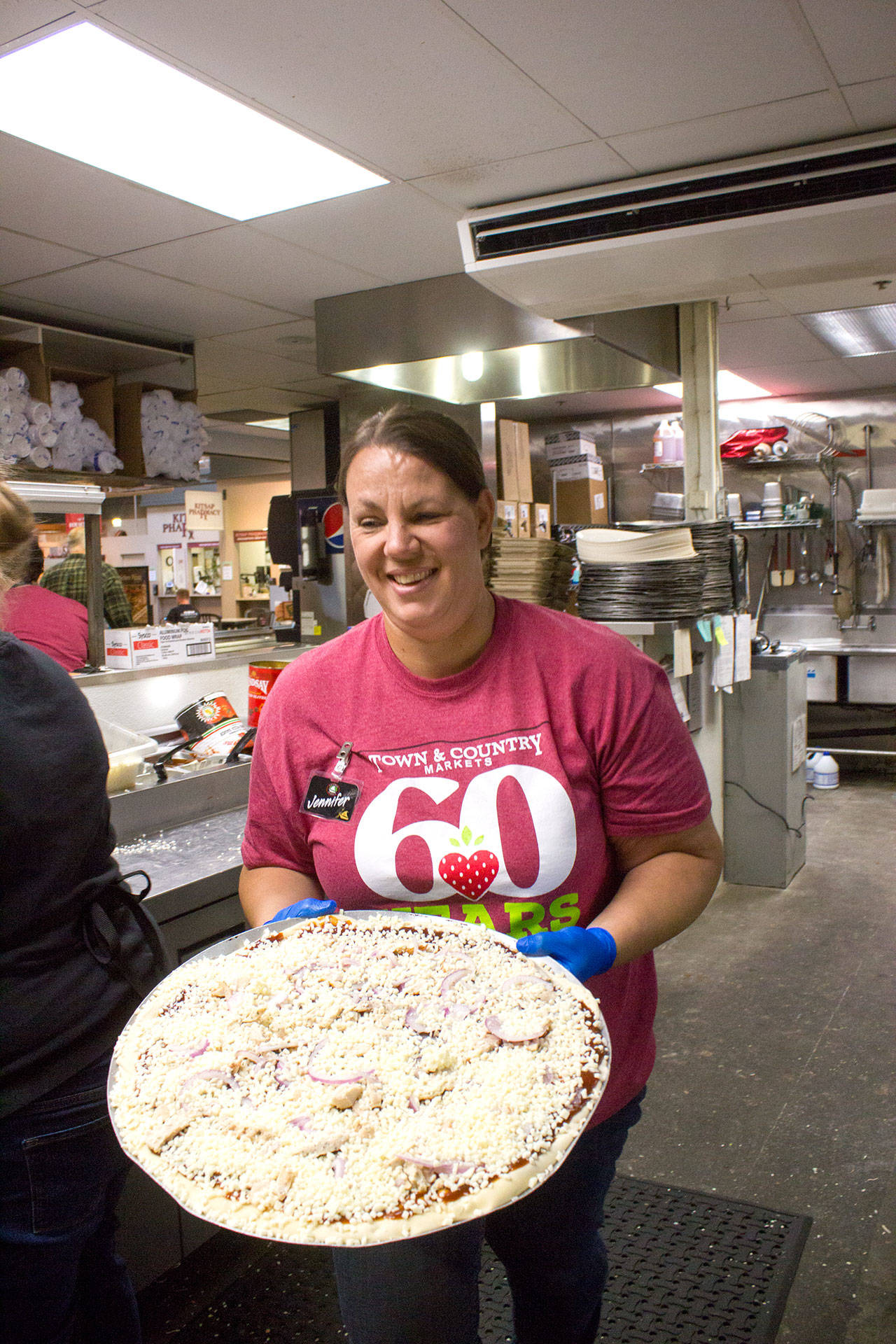 Central Market Pizza & Hot Dogs manager Jennifer Jhonson: “This is a huge family community,” she said of Central Market. “The owners treat employees like people, not some number in the book.” (Sophie Bonomi / Kitsap News Group)
