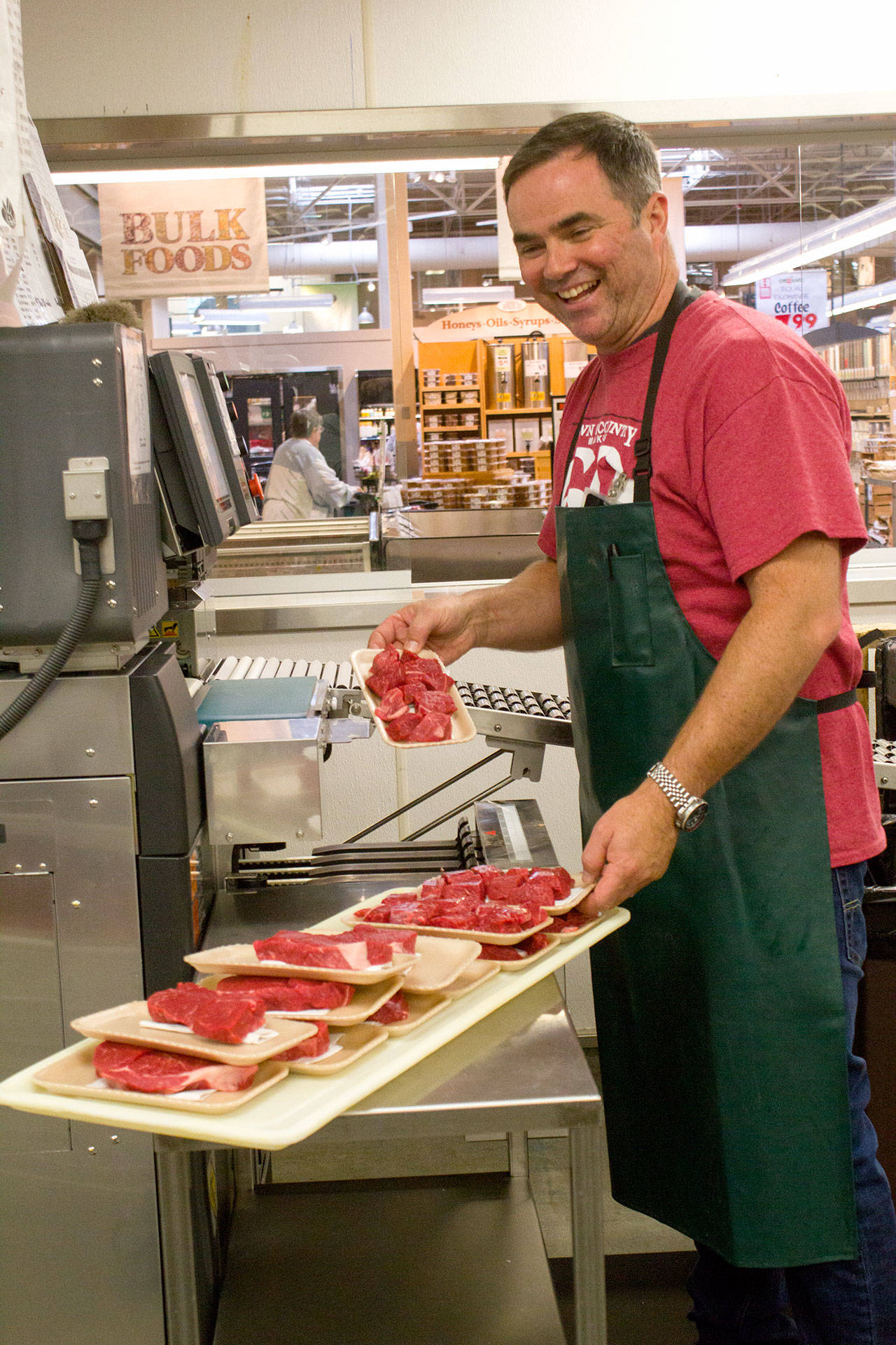 Central Market meat manager Jeremy Geiger: “There’s a sense of family and togetherness you find here that’s kept me here so long. There will always be a place for a store like this, a place in the community, gathering spot for people to come and shop, talk and connect.” (Sophie Bonomi / Kitsap News Group)