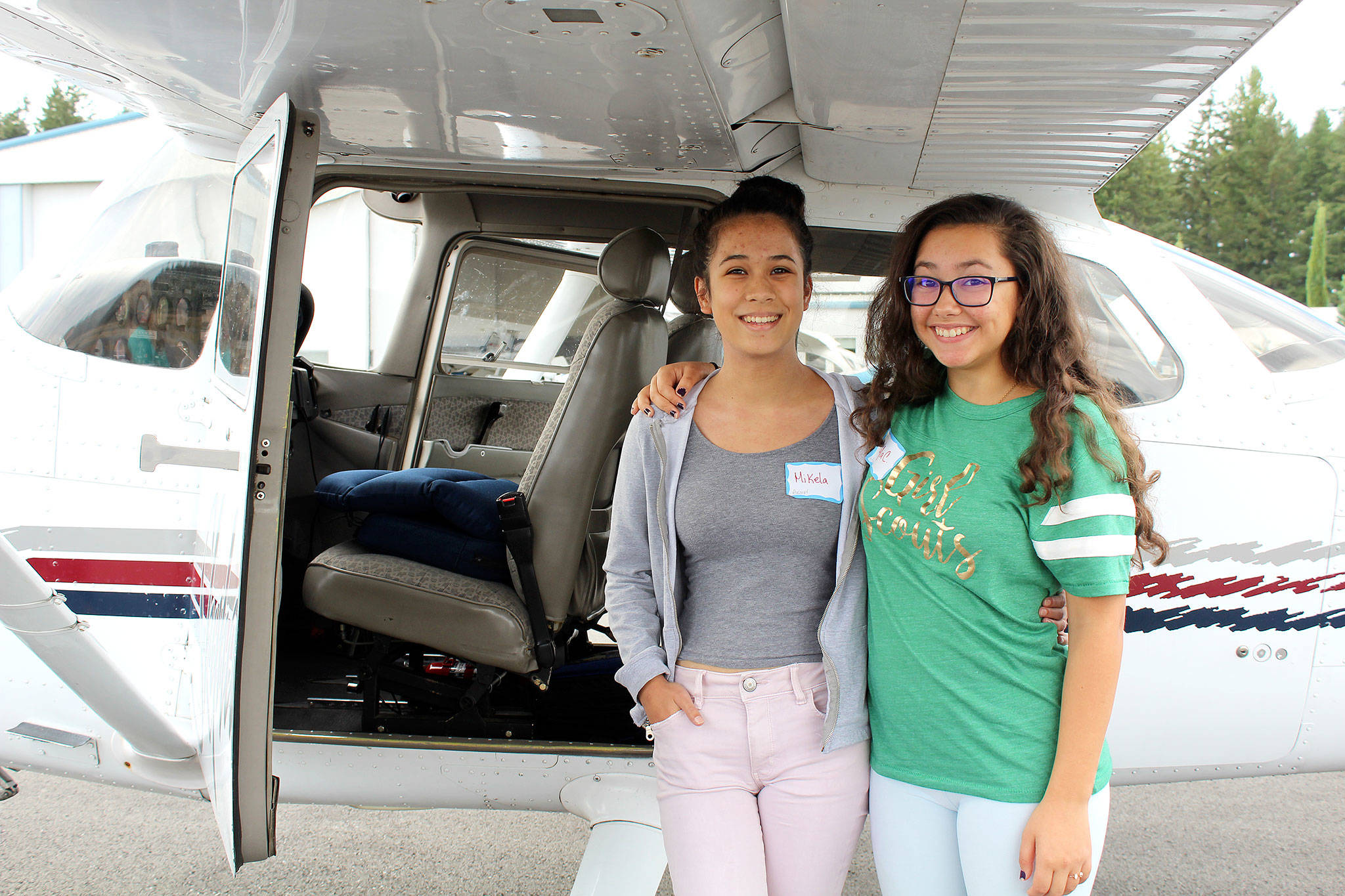 Mikela Arnall, 14, and Kayla Cortes, 15, had the opportunity to fly a plane Aug. 24 above the Bremerton Airport.                                Michelle Beahm / Kitsap News Group
