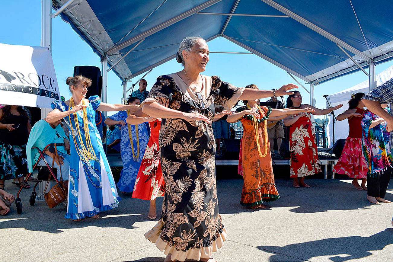 Dancers performing along with Silverdale-based Halau Hula O’ Healani Mai Ka ’ Aina ‘Ona Kumula’au Ki ‘Eki ‘E at the 2017 Pacific Islanders Festival on the Bremerton Boardwalk. (Mark Krulish/Kitsap News Group)