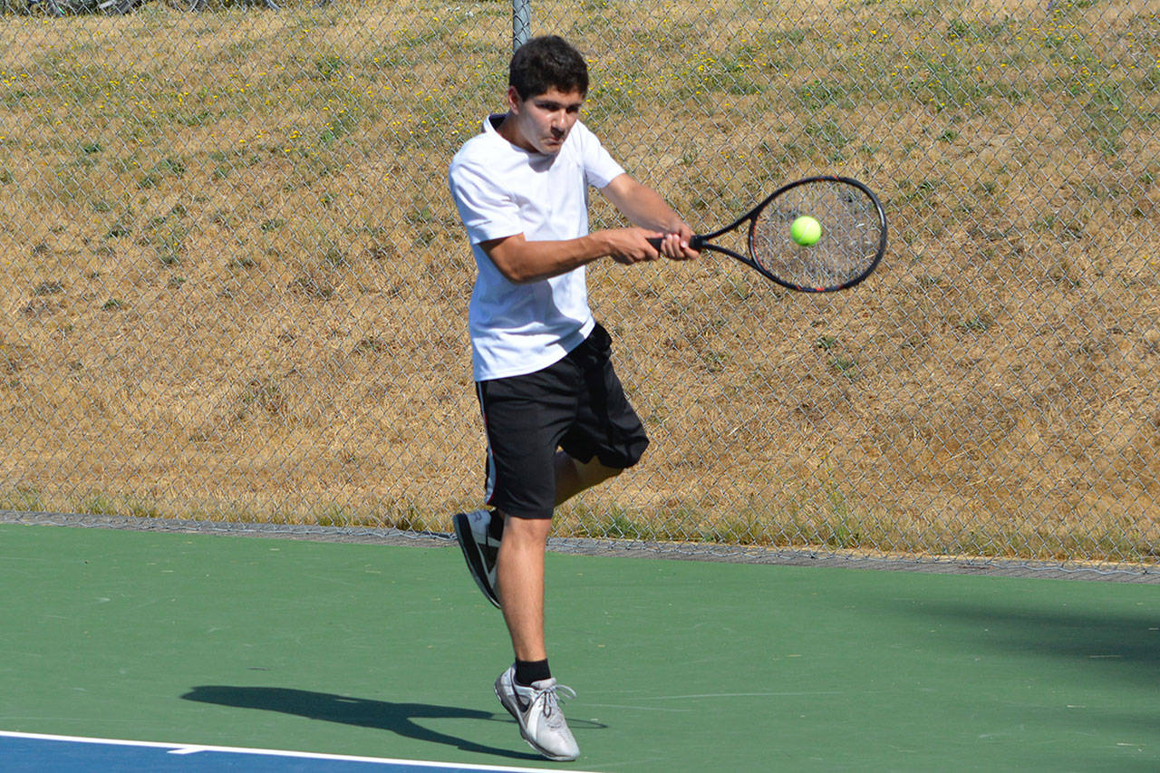 Zachary Wyant backhands the ball during a challenge match at practice. (Mark Krulish/Kitsap News Group)