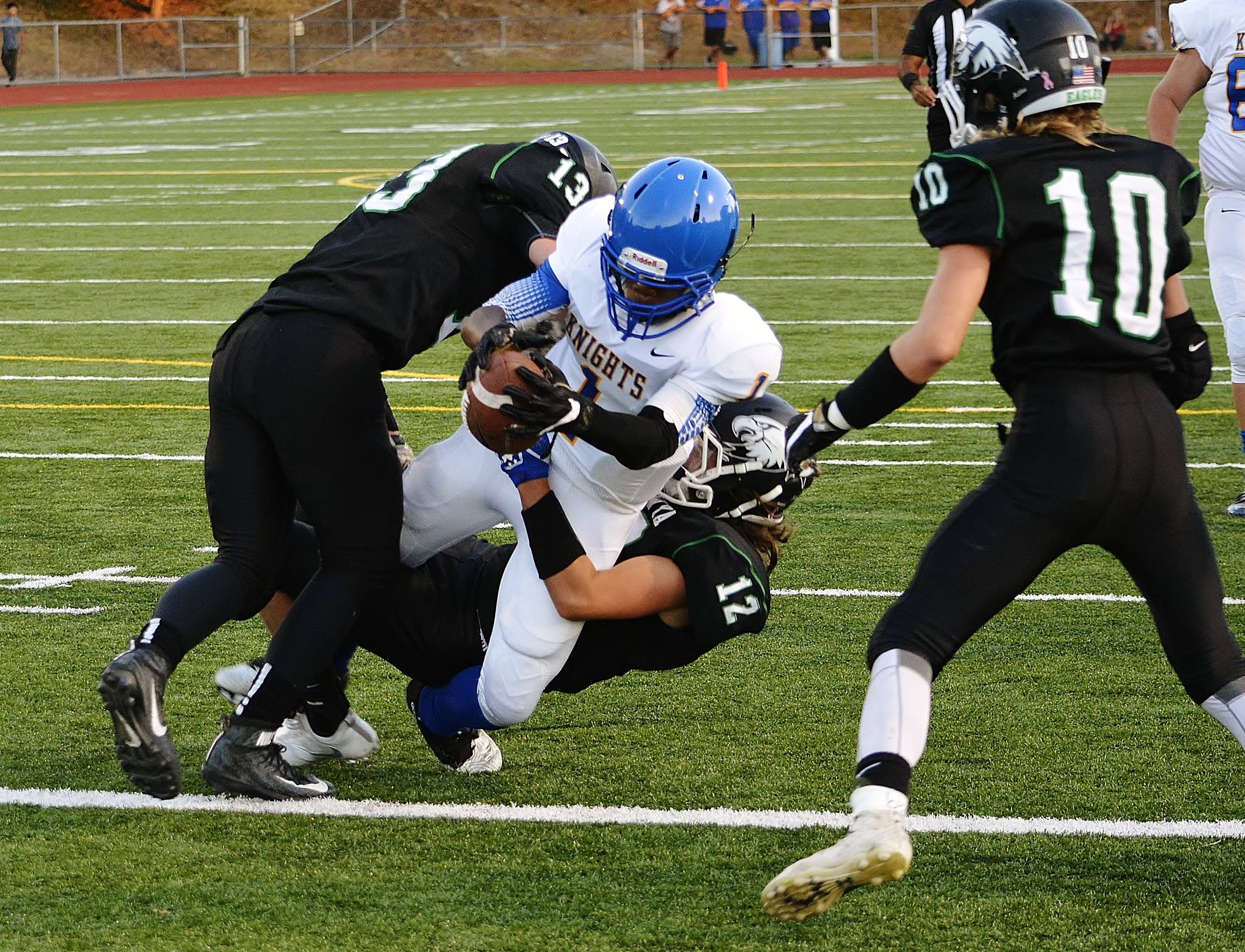 Senior running back SemaJ Cook breaks through the defense to give Bremerton a 13-0 lead in the first quarter. (Mark Krulish/Kitsap News Group)