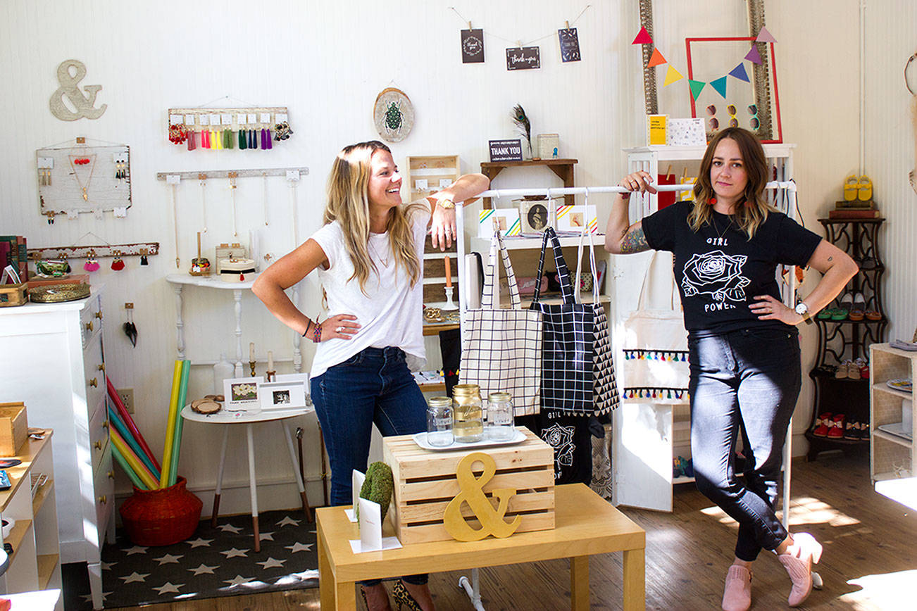 From left, Kelsey Hanson and Emily Young prepare to open their shop Sept. 2. (Sophie Bonomi/Kitsap News Group)