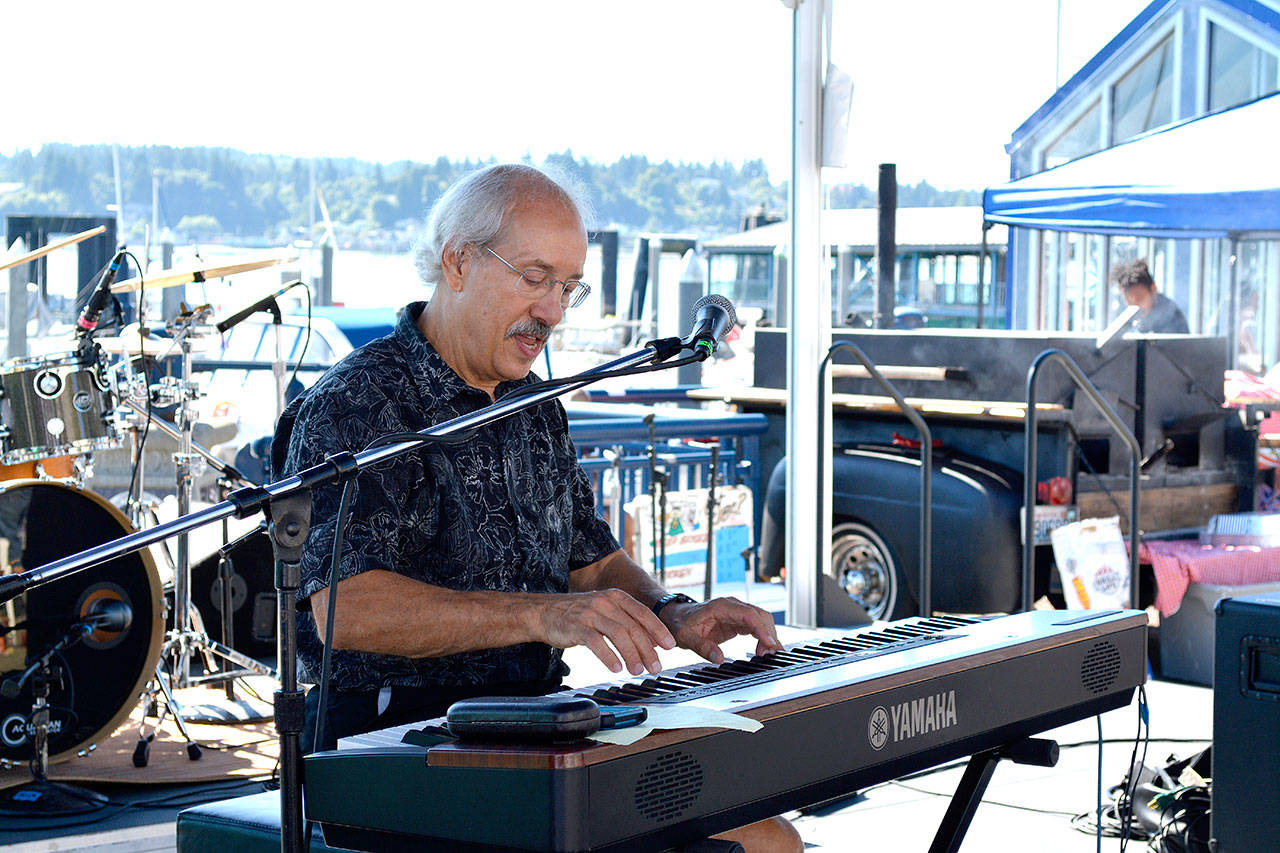 Steve Cossu, a local musician playing as part of a jazz trio, was the first musical act to perform for the crowd at the three-day Blackberry Festival on the Bremerton Boardwalk. (Mark Krulish/Kitsap News Group)