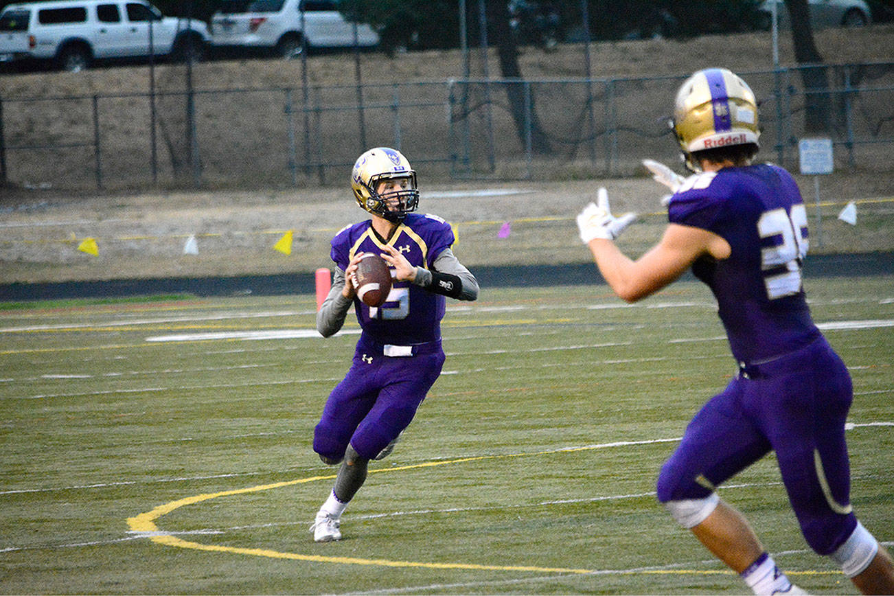 North Kitsap quarterback Andrew Blackmore (15) looks for an open receiver downfield in his team’s 25-14 win over Central Kitsap. (Mark Krulish/Kitsap News Group)