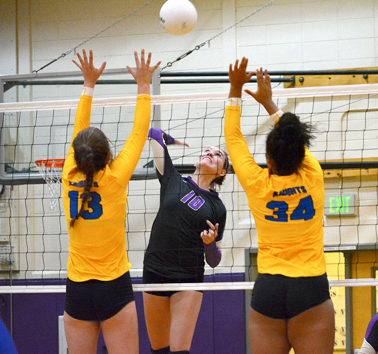 North Kitsap’s Riley Rabedeaux (10) goes up for a spike as Bremerton’s Lily Gelhaus (13) and Adia Anderson (34) try to block the scoring attempt.                                Mark Krulish/Kitsap News Group