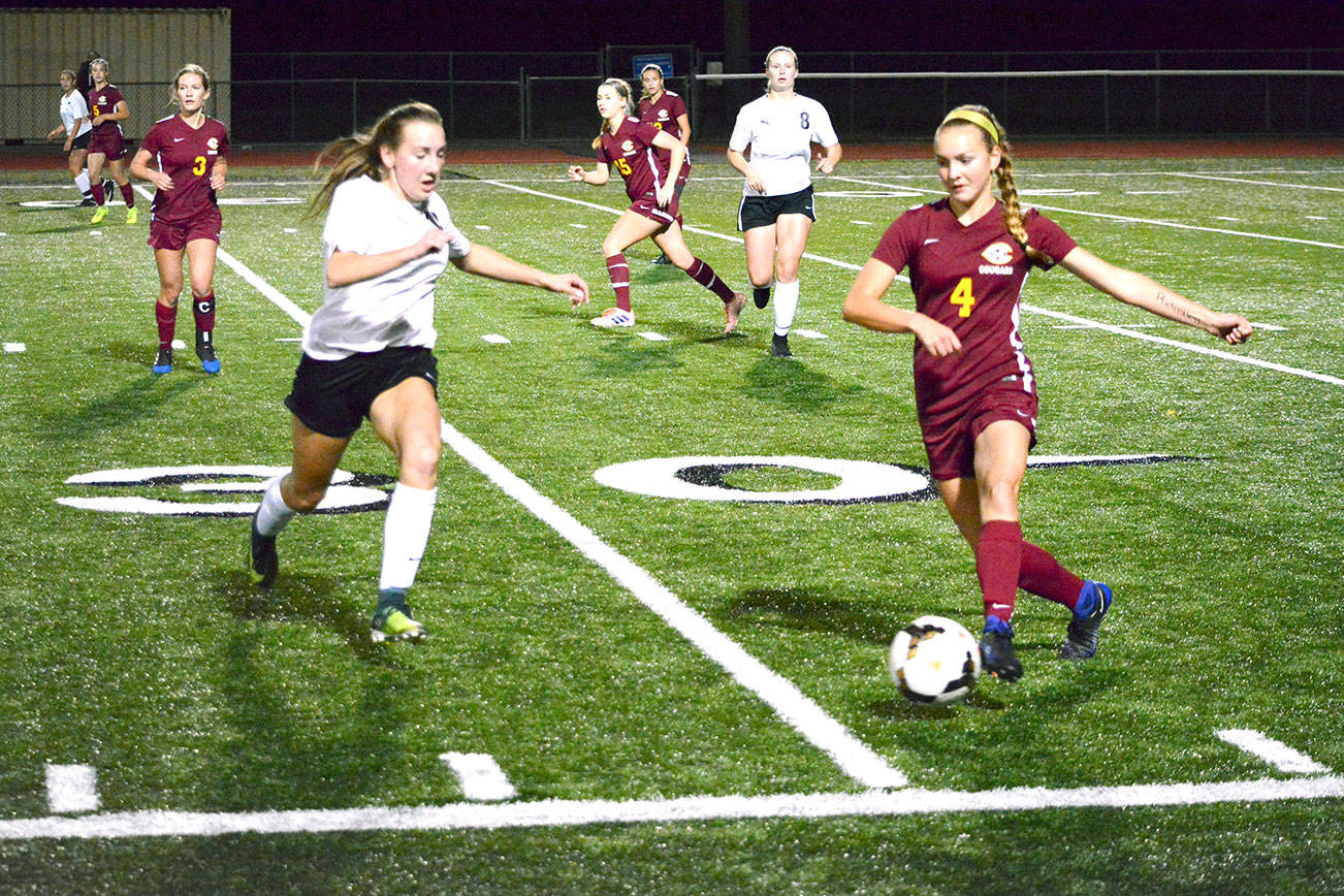 Central Kitsap’s Autumn Mullins chases down Capital’s Maddie Thompson (4) during her team’s 3-0 victory on Oct. 3.                                 Mark Krulish/Kitsap News Group