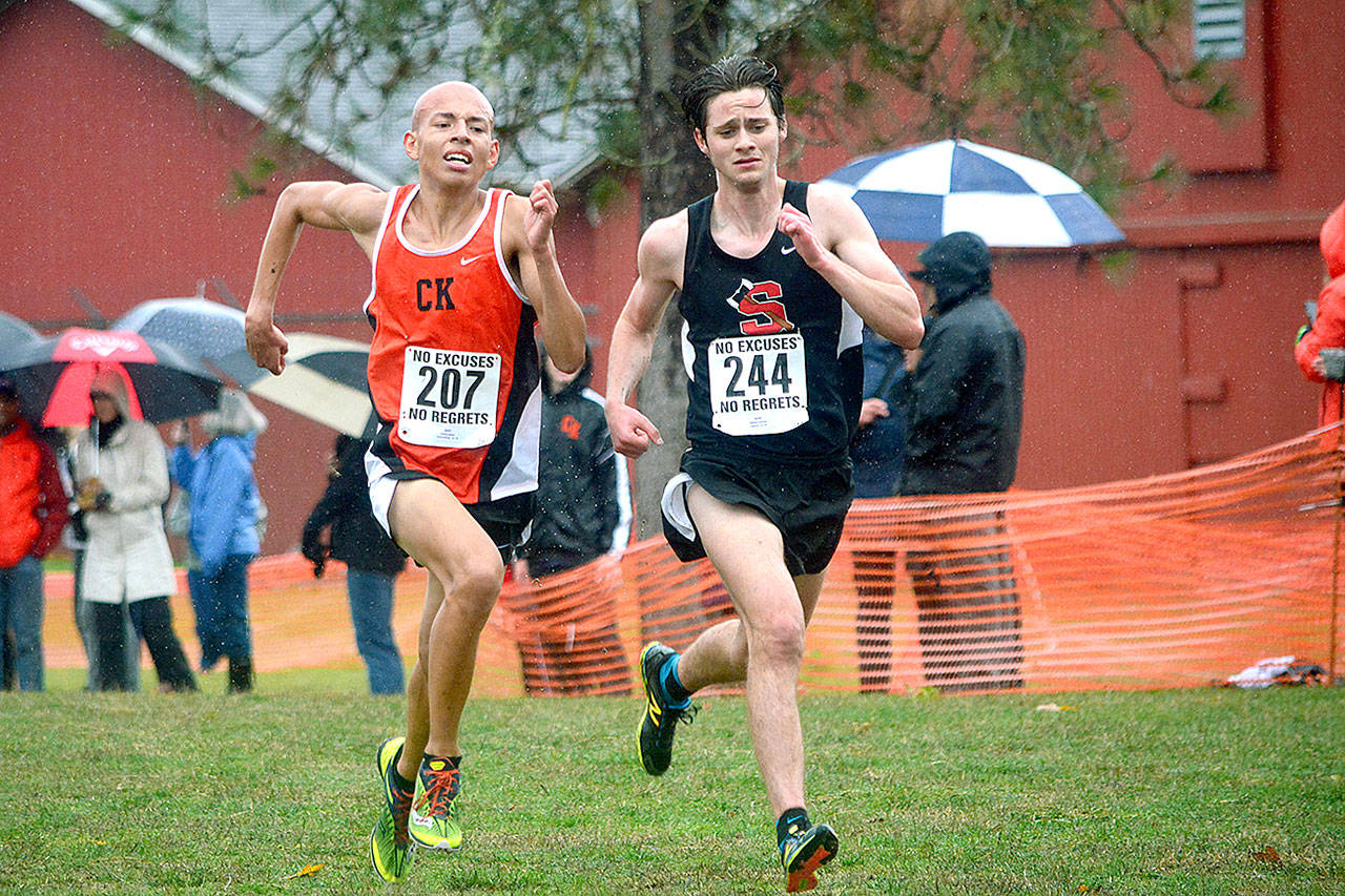 Joshua Geiser (left) of Central Kitsap runs neck-and-neck with William Johnson of Shelton during the boys race at the South Sound Conference championship meet. (Mark Krulish/Kitsap News Group)