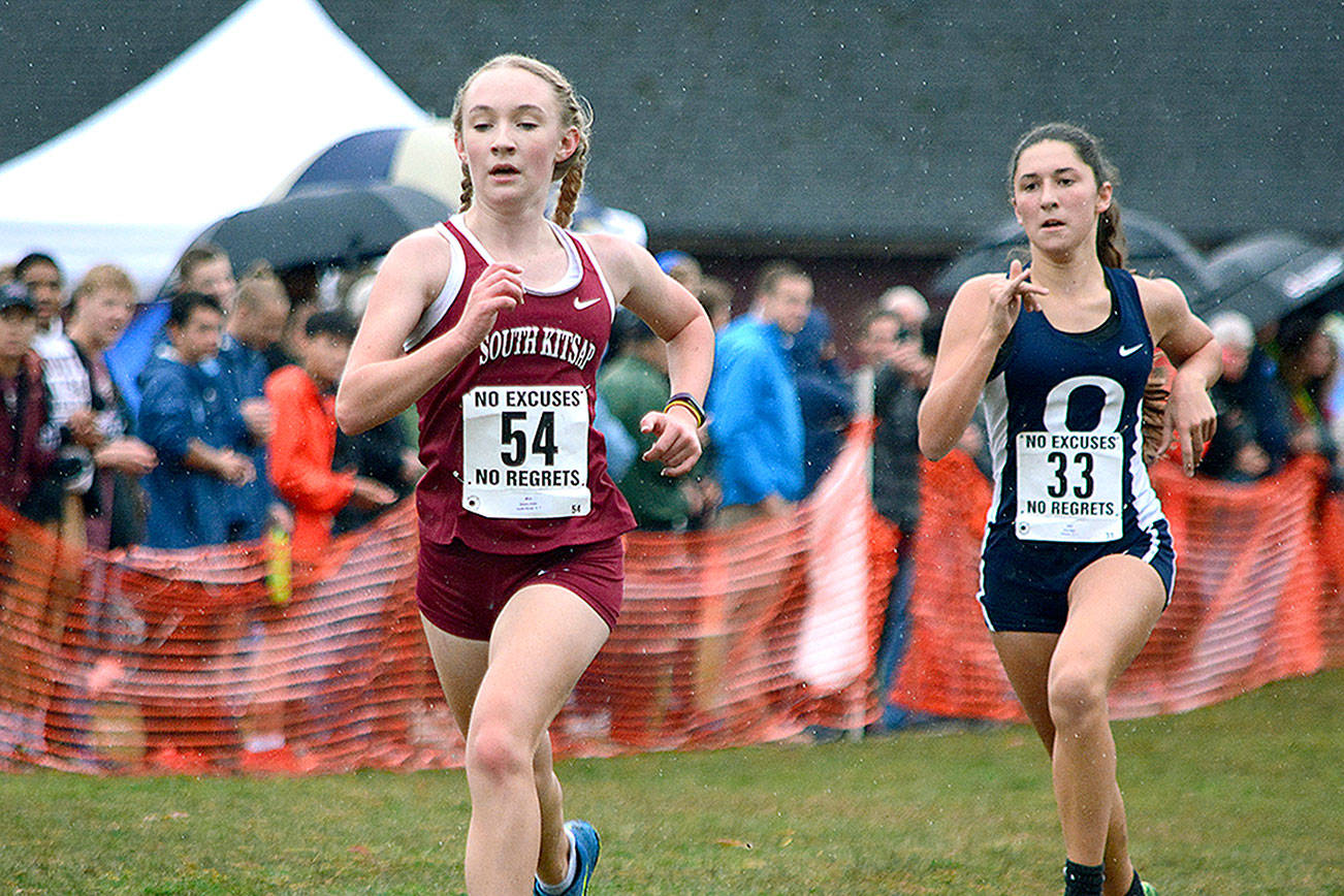 South Kitsap freshman Emma Orser finishes just ahead of Olympia’s Kate Riggs during the South Puget Sound League championship meet on Oct. 19. (Mark Krulish/Kitsap News Group)