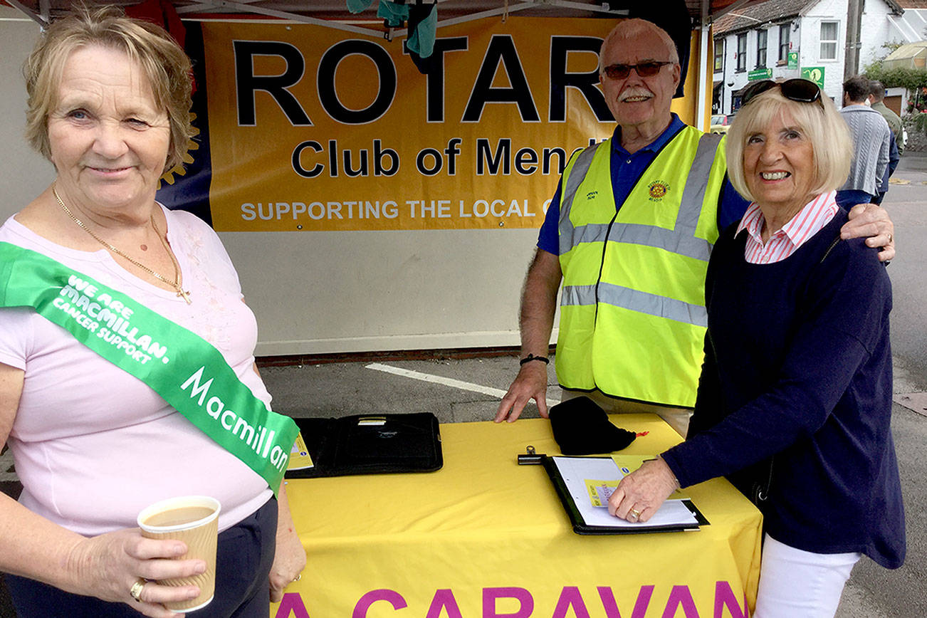 Rotarians in Cheddar Gorge, England, sell raffle tickets at a farmers market in their town. The proceeds were to go to a local charity, MacMillan House, where cancer victim families stay during treatment (think Pete Gross House in Seattle).                                Ron Carter/Rotary News