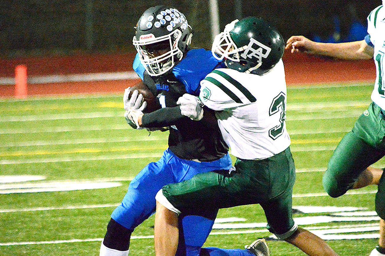 Olympic running Malcolm Dewalt turns the corner against Port Angeles on Oct. 26. The Trojans won the game 59-13. (Mark Krulish/Kitsap News Group)