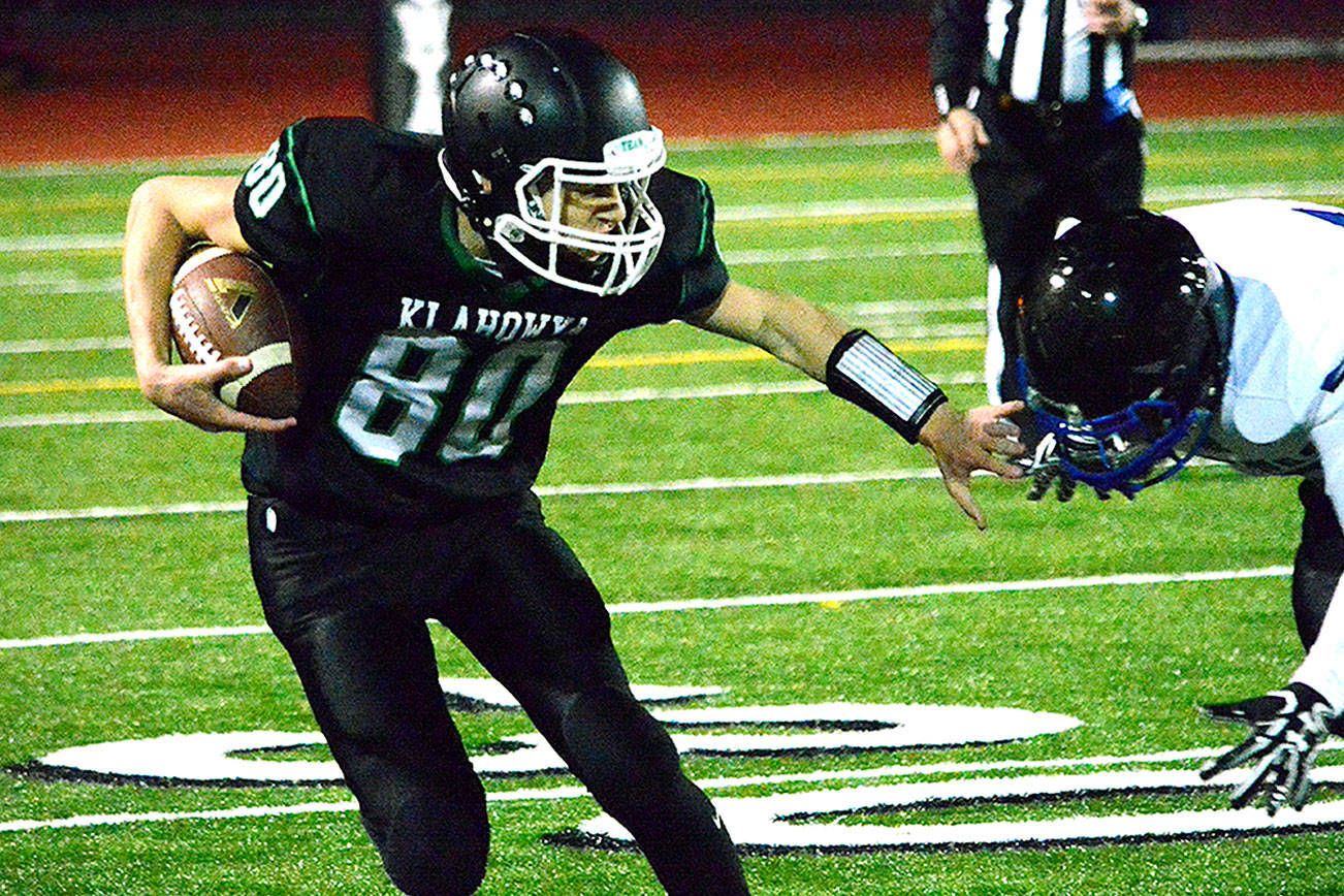 Klahowya receiver Jacob Keppert (80) slips away from the tackle of a Bellevue Christian defender during his team’s 14-7 loss on Oct. 28. (Mark Krulish/Kitsap News Group)