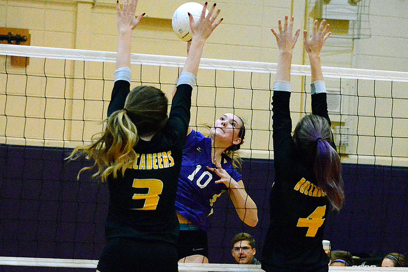 North Kitsap’s Riley Rabedeaux (10) tries to place her spike against Kingston blockers Grace Baze (3) and Alyssa Duckworth (4). The Vikings won the match and the Olympic League championship in three sets. Mark Krulish/Kitsap News Group