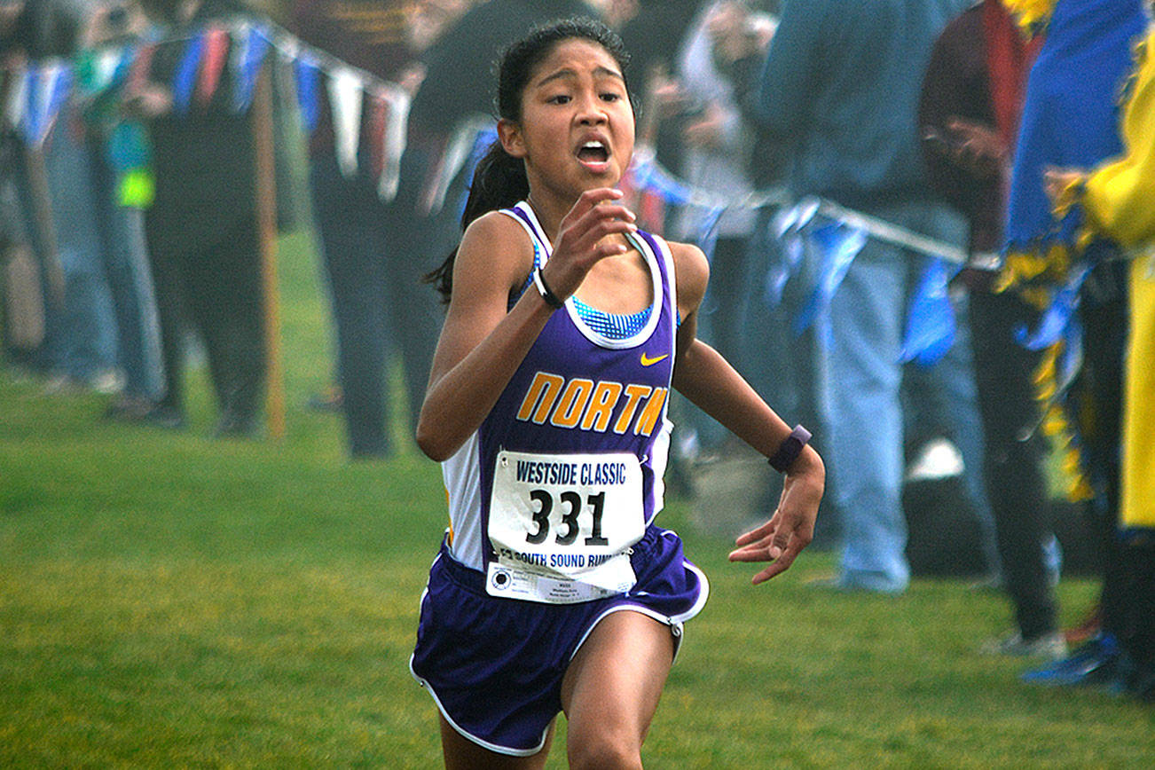 North Kitsap freshman Madison Zosa sprints to the finish line at the West Central District meet on Oct. 28 at Chambers Bay. She won the race with her time of 19:19.70. Mark Krulish/Kitsap News Group