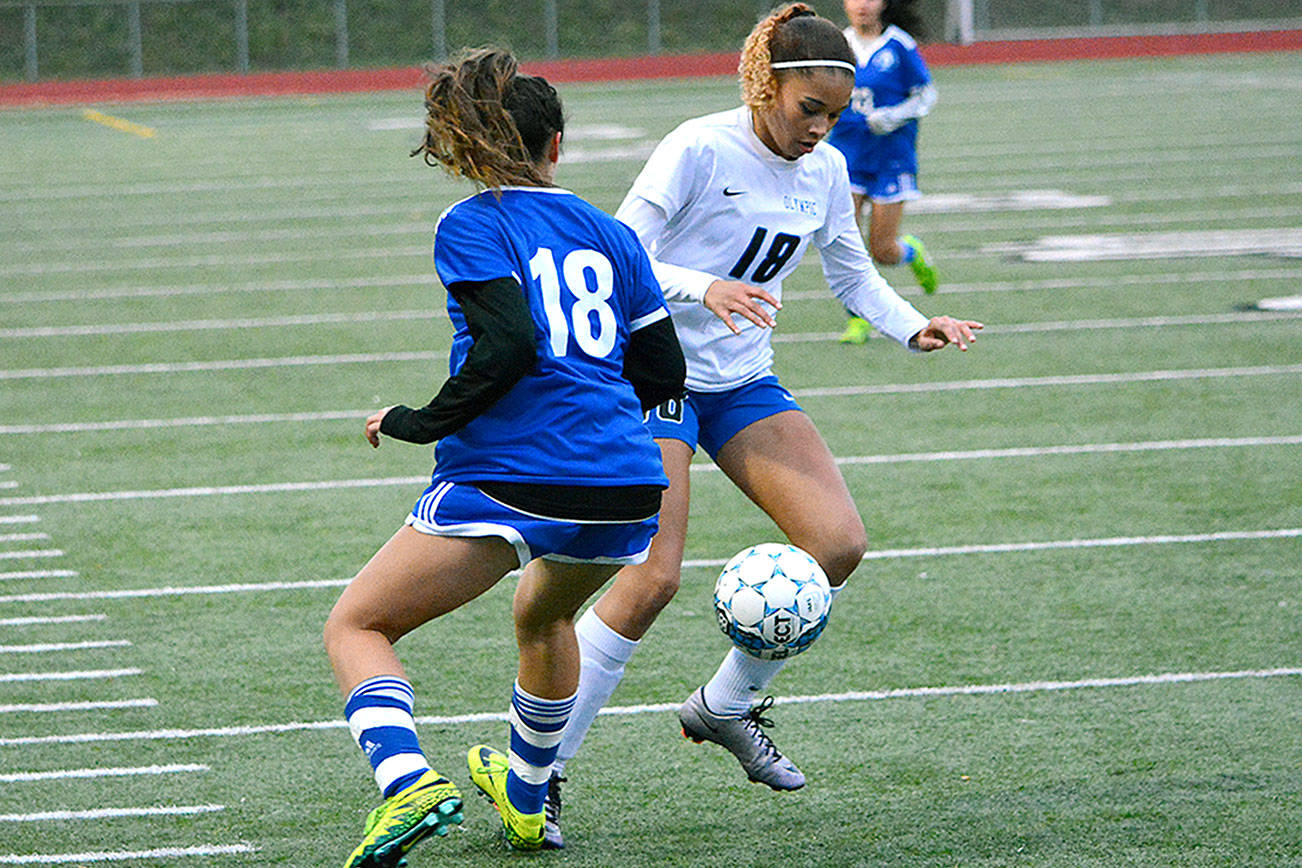 Olympic’s Saoirse Brown tries to dribble past her numeral counterpart during a district game against Fife. The Trojans won 4-0. (Mark Krulish/Kitsap News Group)